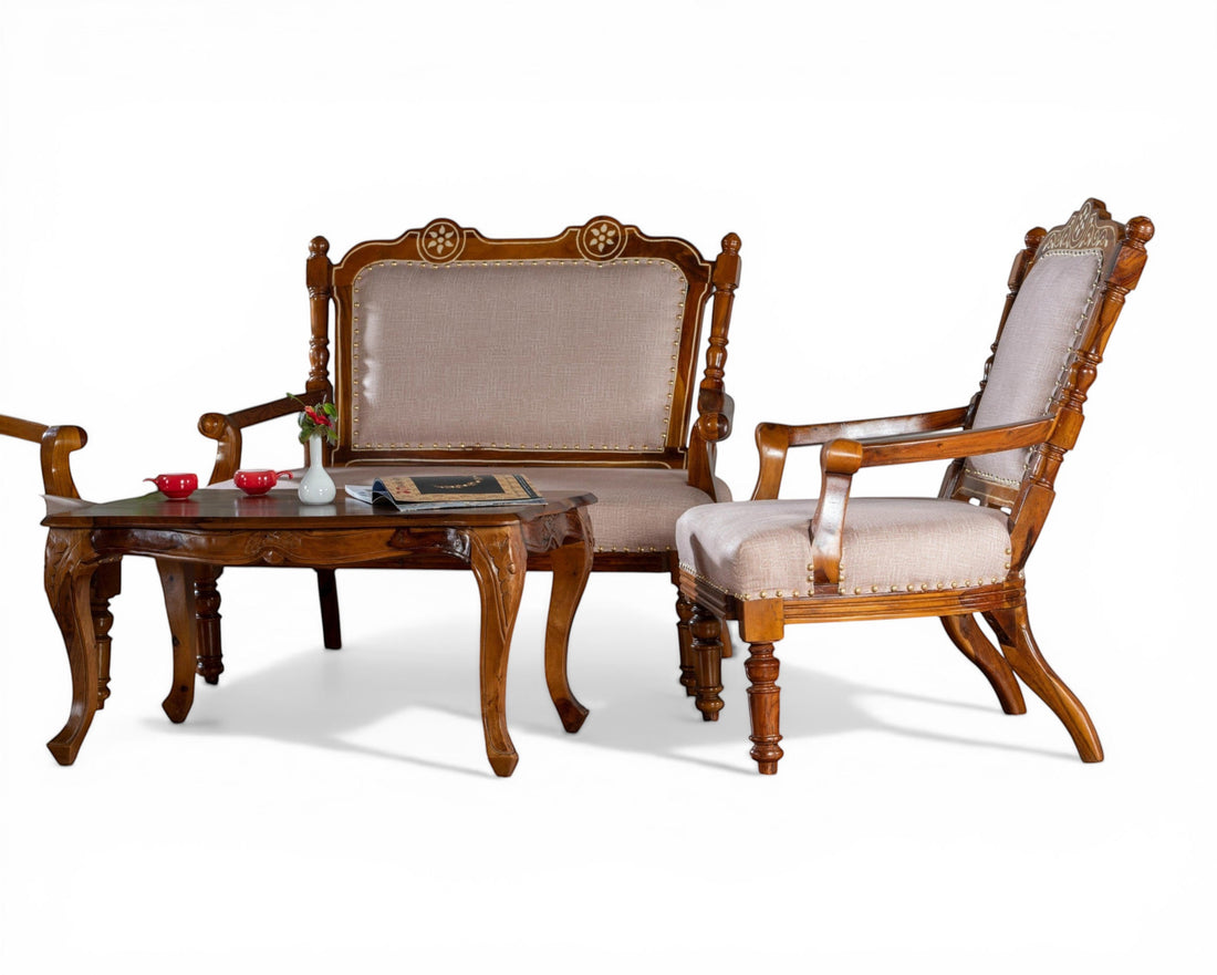 Nakoda Homes ornate carved wood armchair with neutral upholstered seat and back, nailhead trim, and curved legs.