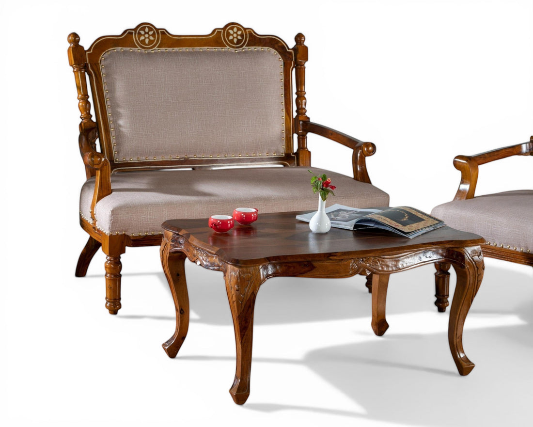 Nakoda Homes ornate carved wood armchair with neutral upholstered seat and nailhead trim, elegant curved legs.