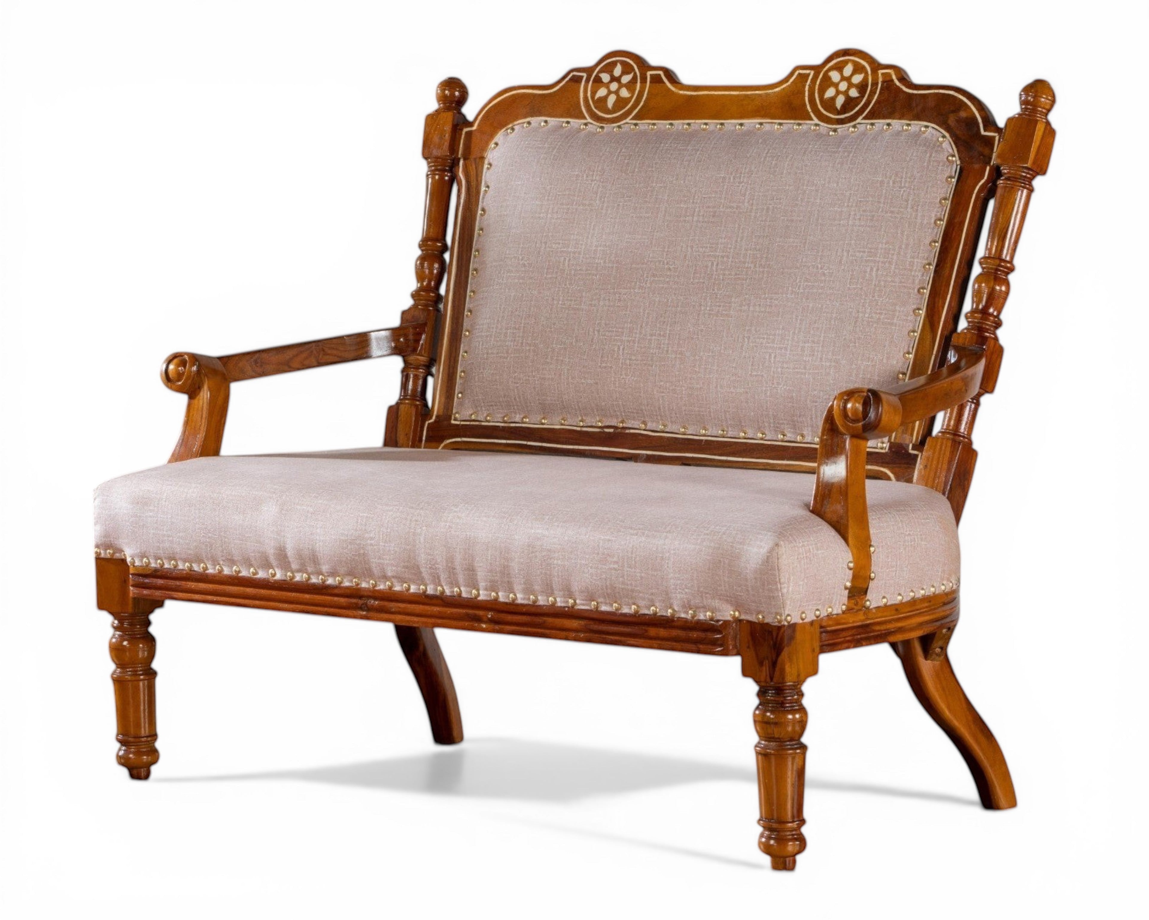 Nakoda Homes ornate carved wood armchair with neutral upholstered seat and back, decorative nailhead trim, and curved legs.
