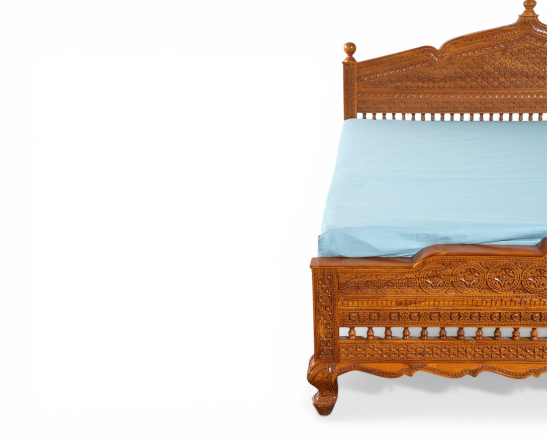 Nakoda Homes ornate carved wooden bed frame with intricate details and warm wood finish. Traditional craftsmanship.
