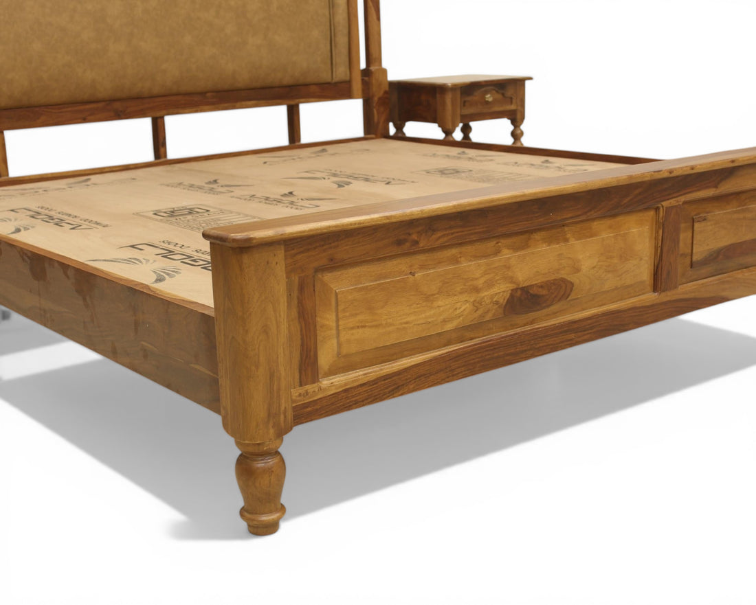 Nakoda Homes ornate wooden bed frame with neutral padded headboard and built-in storage drawers.