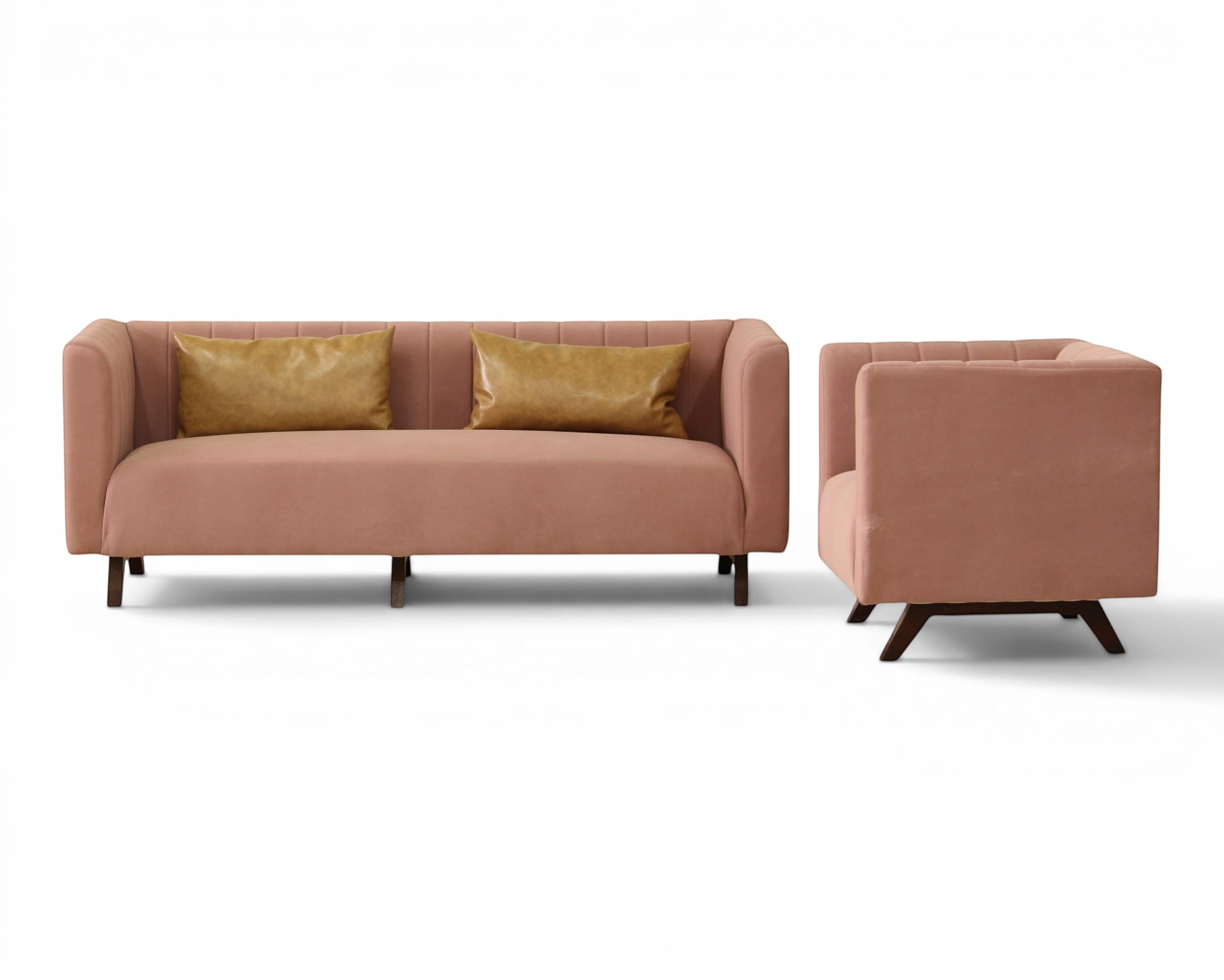 Nakoda Homes modern rose velvet sofa with channel tufting and faux leather accent pillows on dark wood legs.
