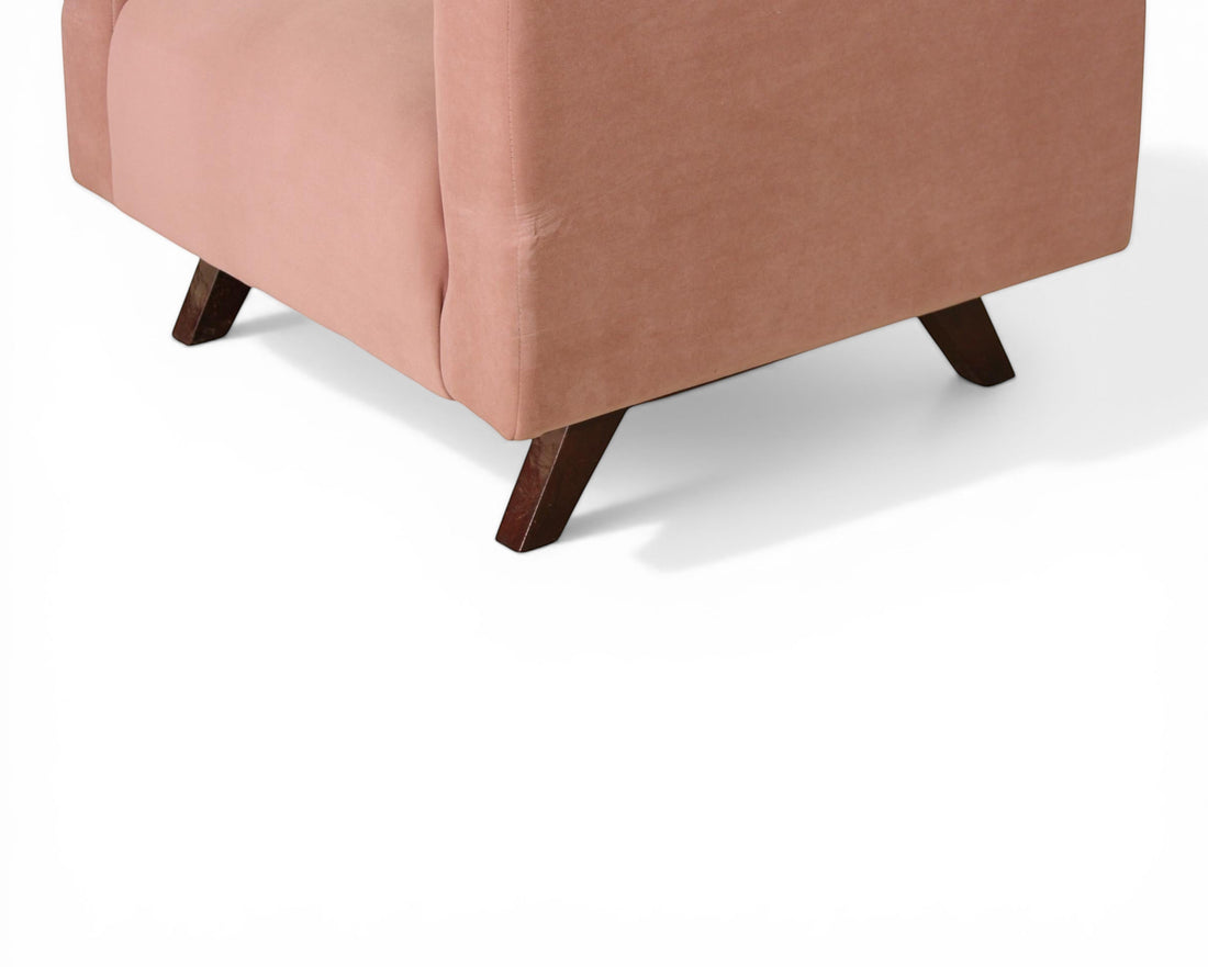 Nakoda Homes rose velvet sofa with channel tufting and dark wood legs, perfect for modern living spaces.