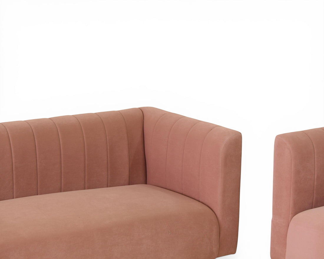 Nakoda Homes modern rose velvet sofa with channel tufting and dark wood legs. Plush upholstery for comfortable seating.
