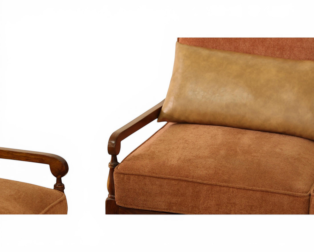 Nakoda Homes rust-colored upholstered sofa with wooden arms and tan faux-leather lumbar pillow.