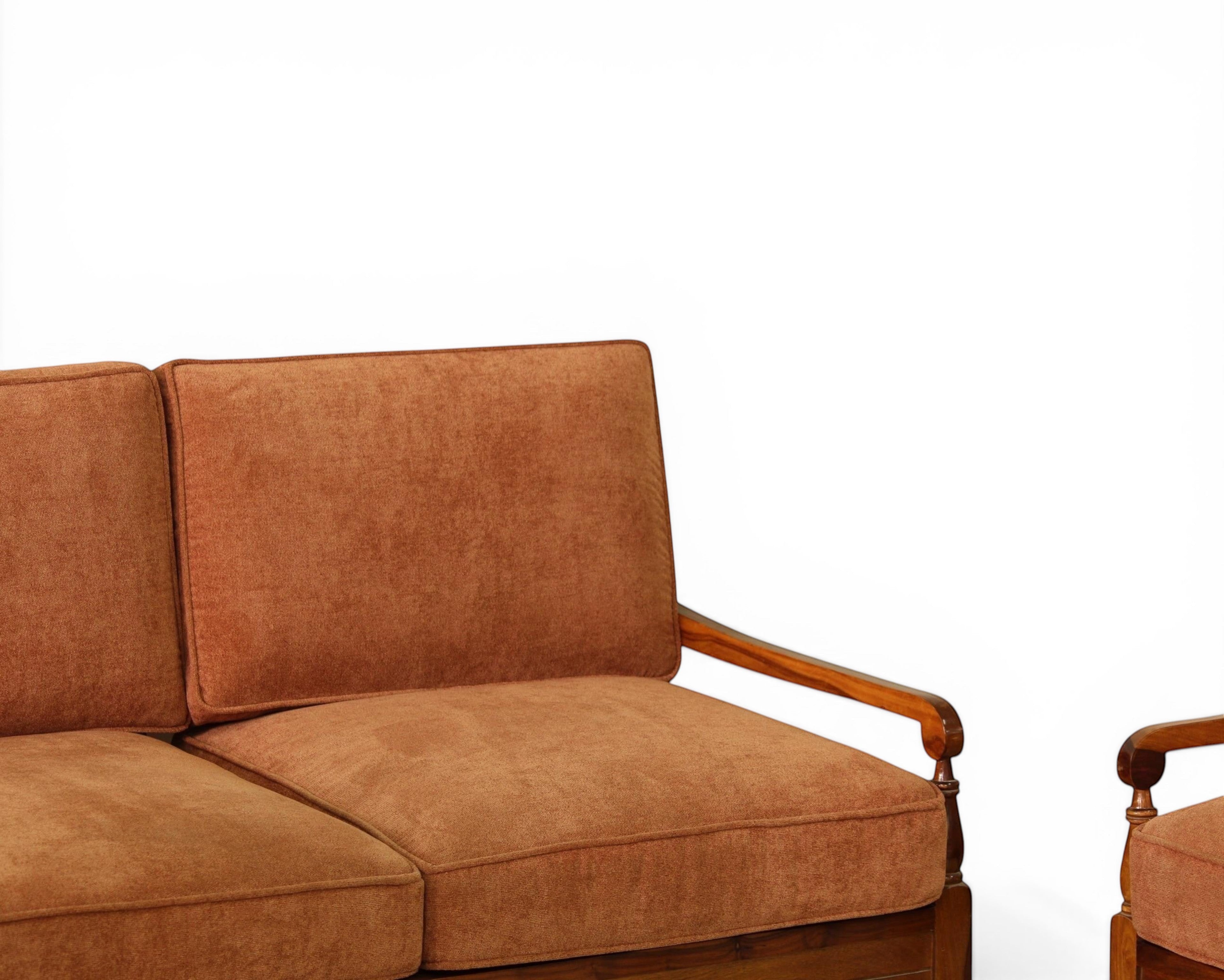 Nakoda Homes 3-piece rust-colored upholstered sofa set with wooden frame and armrests, featuring plush fabric and tan lumbar pillows.