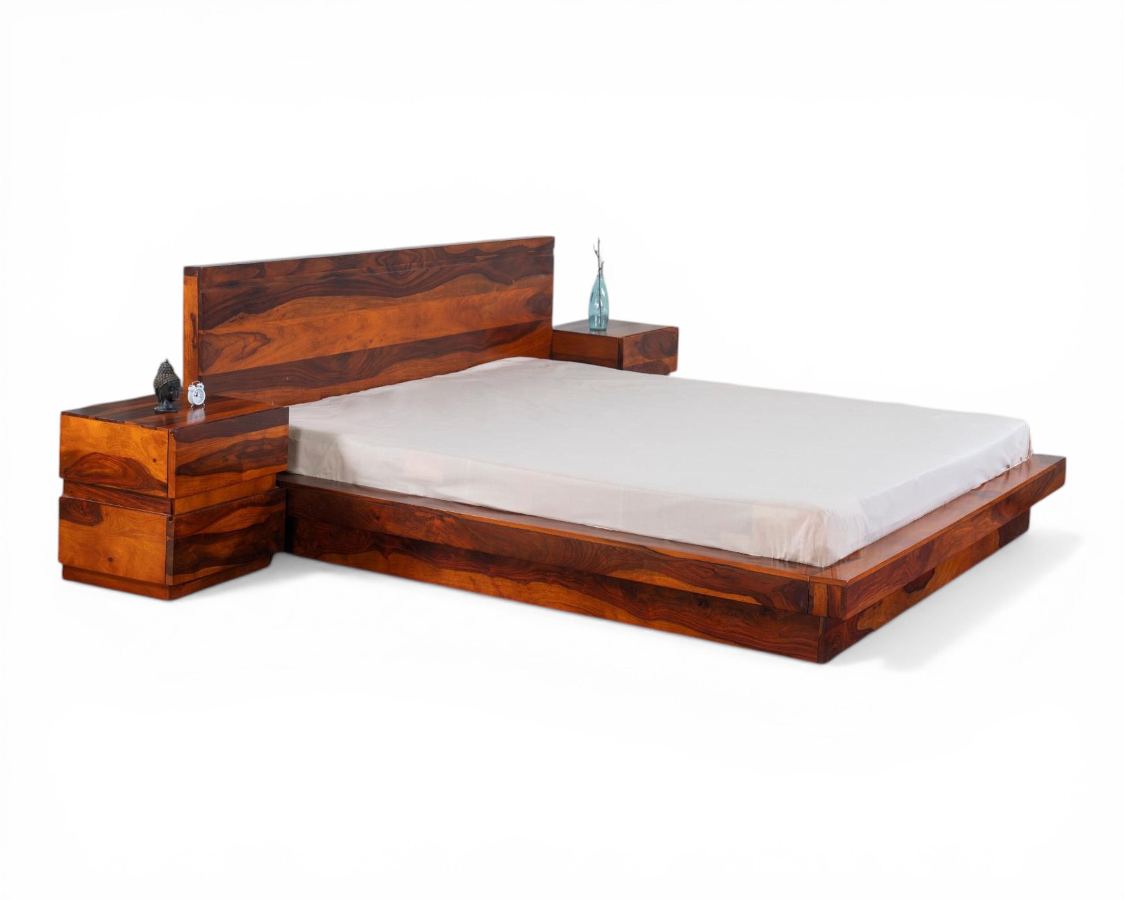 Nakoda Homes solid Sheesham wood platform bed frame with minimalist headboard and matching nightstands.