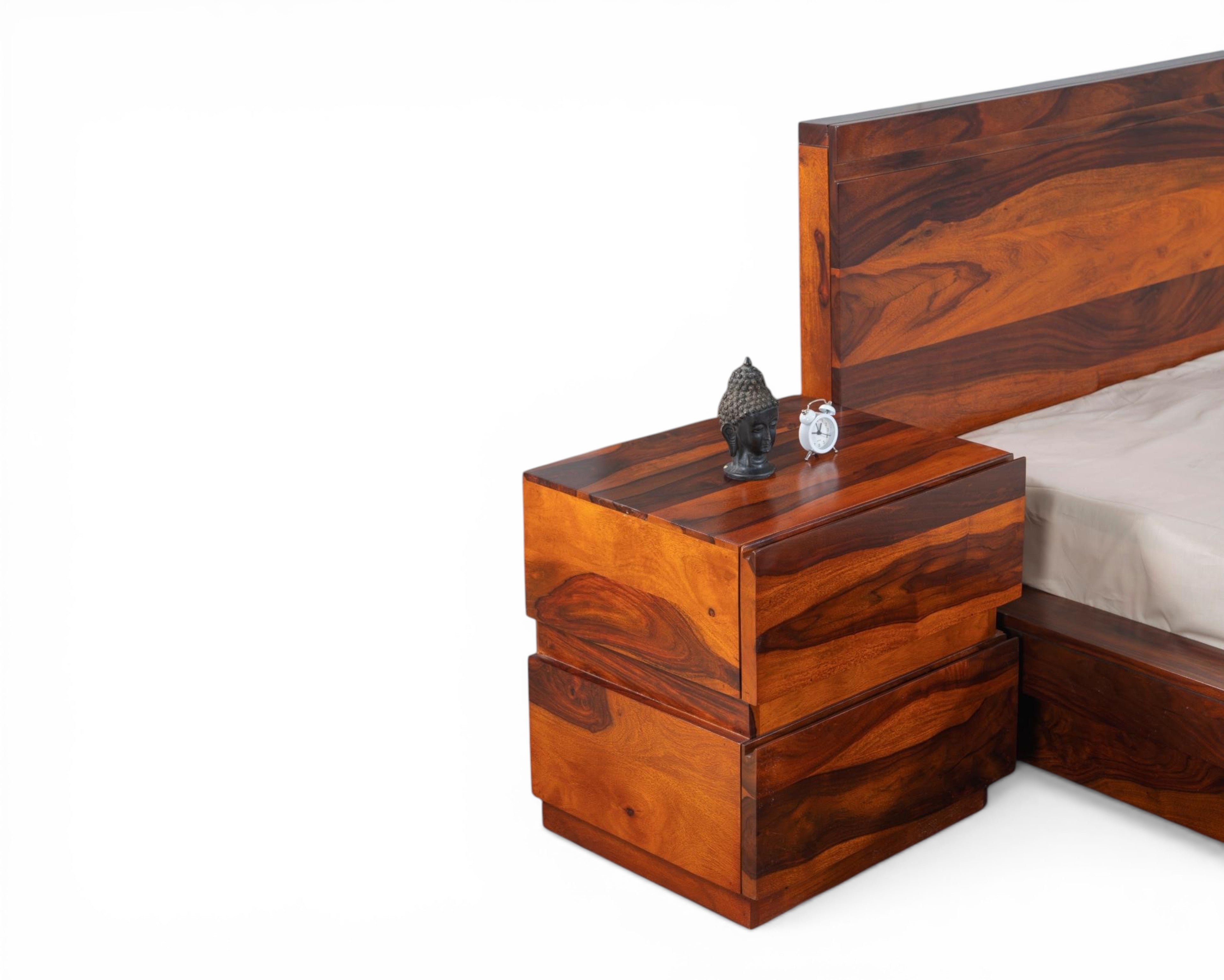 Nakoda Homes solid Sheesham wood platform bed frame with natural grain and minimalist headboard. Warm wood tones.
