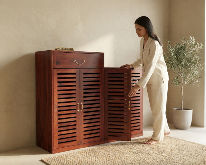 Nakoda Homes Sheesham wood entryway shoe storage cabinet with slatted doors and a drawer.
