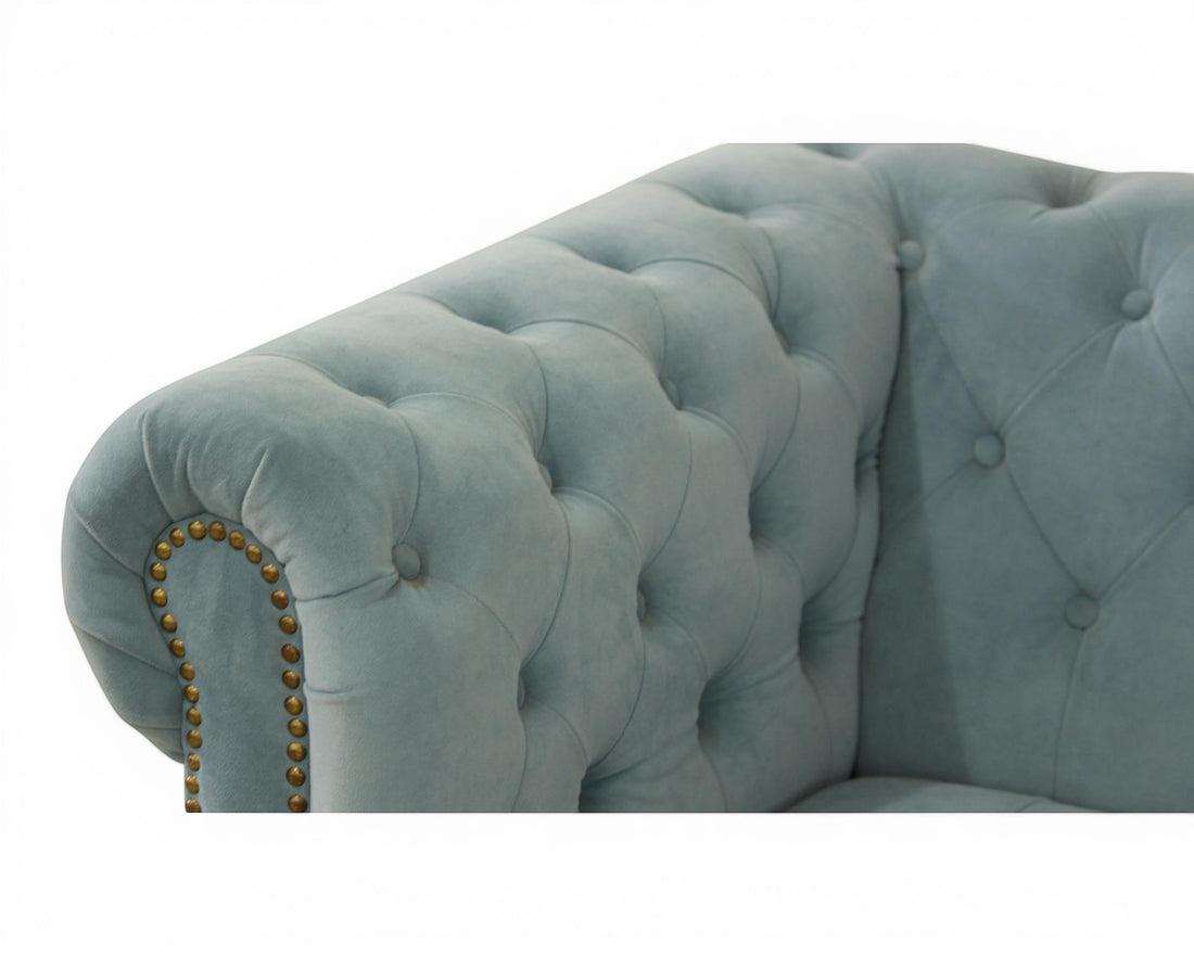 Nakoda Homes sky blue velvet Chesterfield sofa with deep button-tufting and nailhead trim.