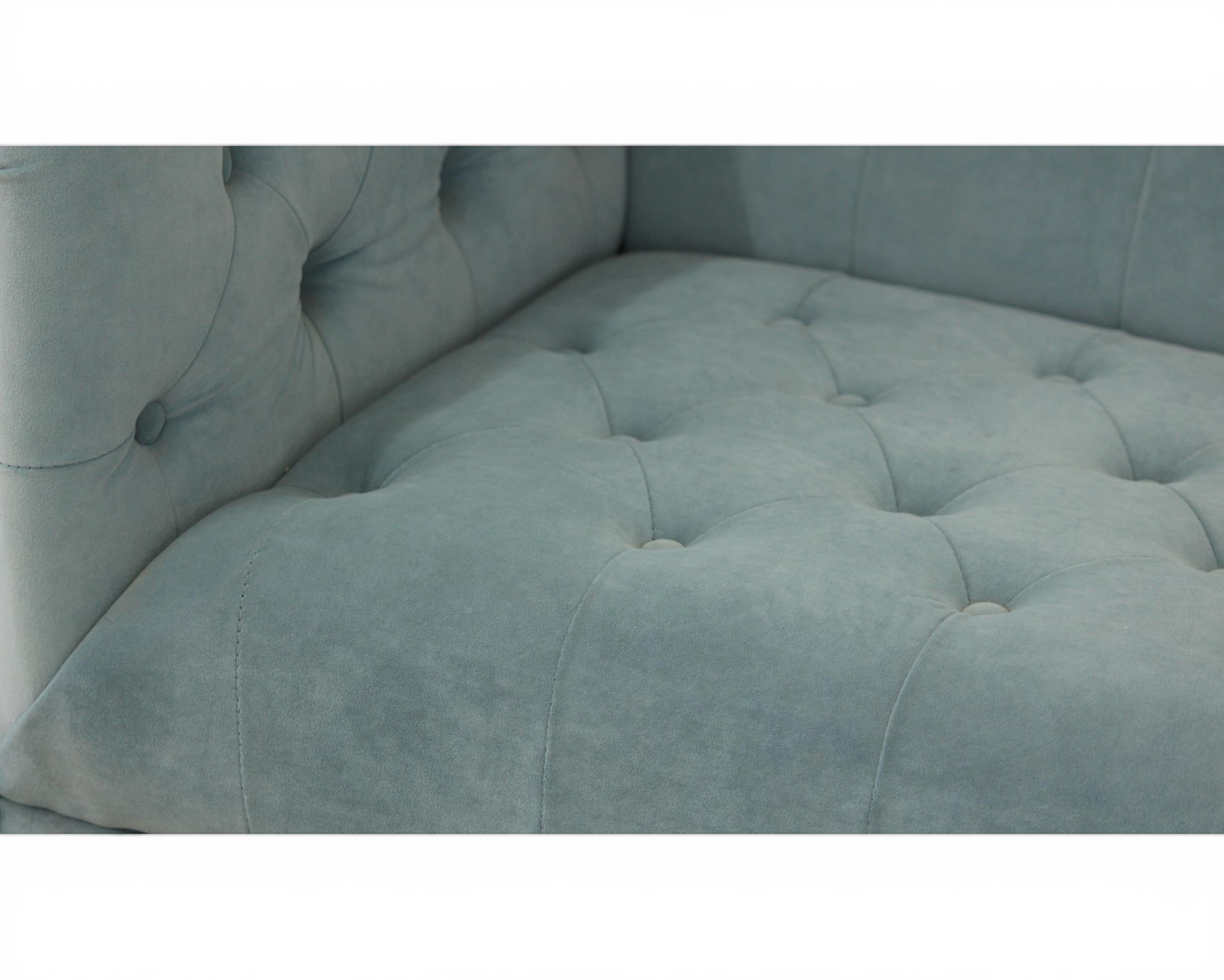 Nakoda Homes sky blue velvet tufted Chesterfield sofa with button details and rolled arms.
