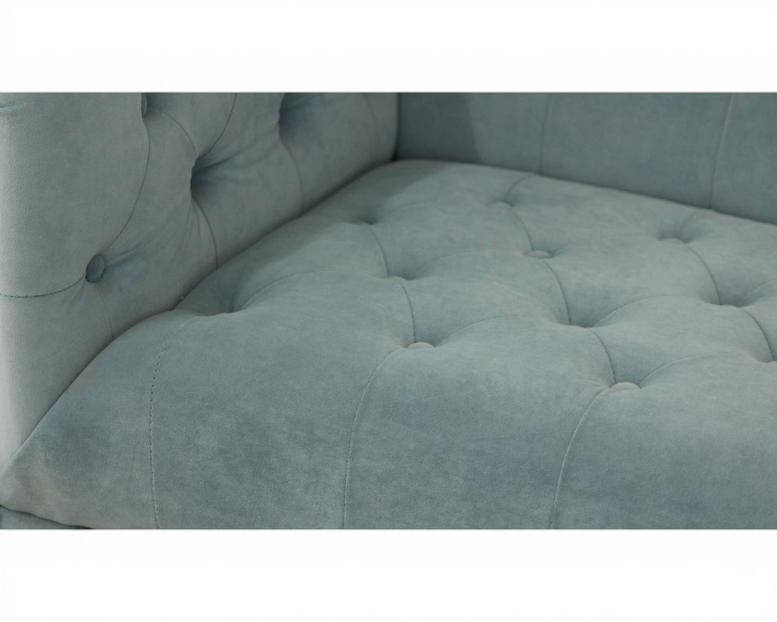 Nakoda Homes sky blue velvet tufted Chesterfield sofa with button details and rolled arms.