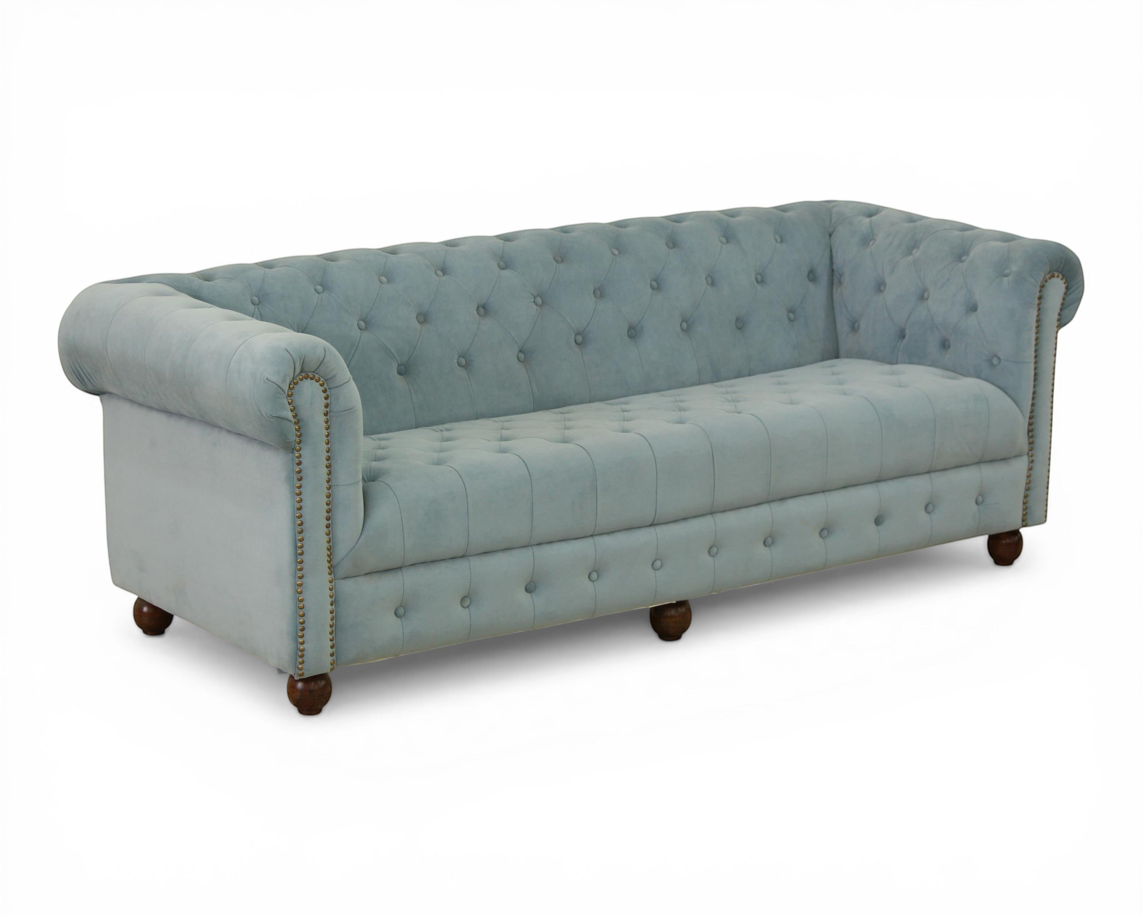 Nakoda Homes sky-blue velvet Chesterfield sofa with deep button-tufting, rolled arms, and nailhead trim.