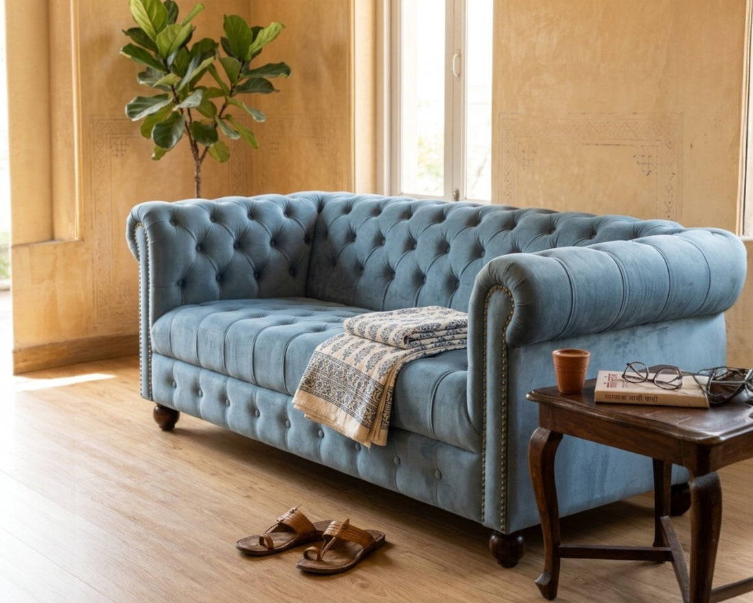 Nakoda Homes sky blue velvet Chesterfield sofa with deep button-tufting, rolled arms, and nailhead trim.
