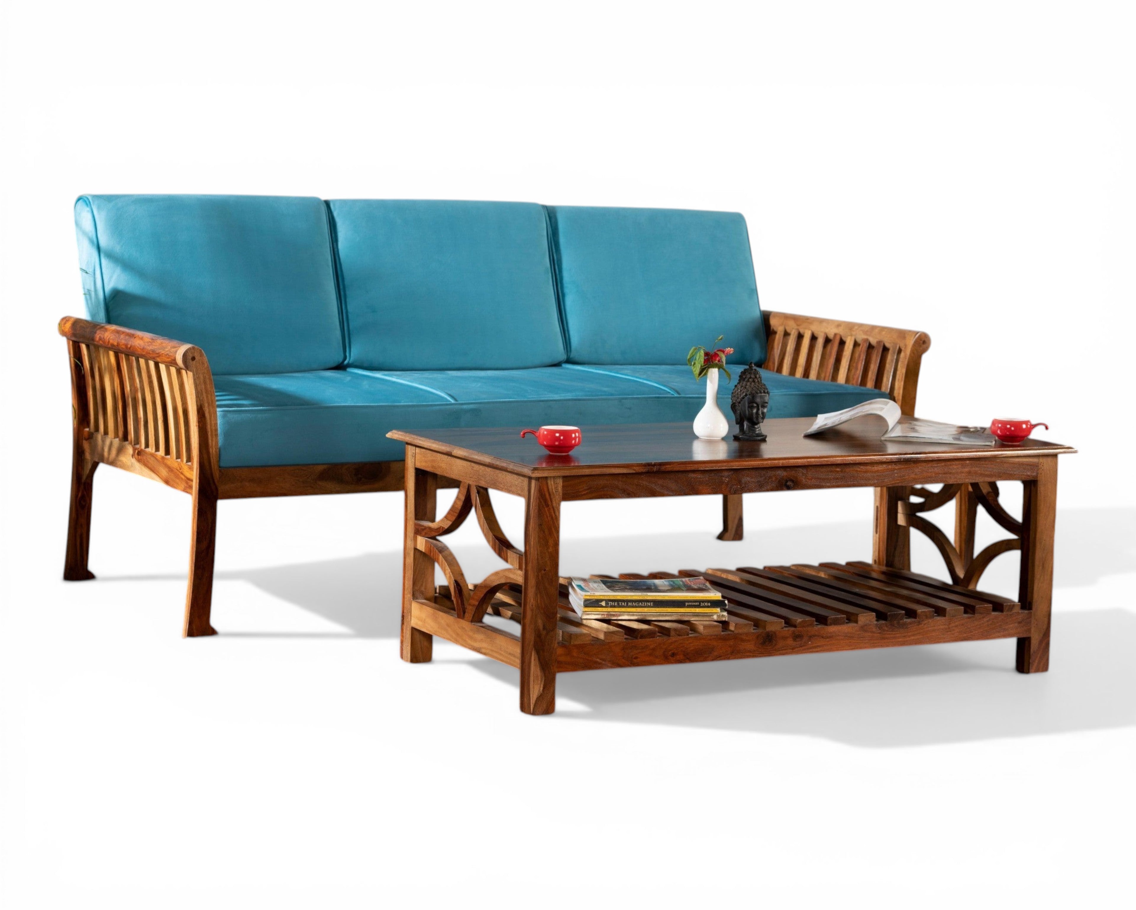 Nakoda Homes solid wood coffee table with geometric lattice sides and slatted shelf, paired with a blue sofa.