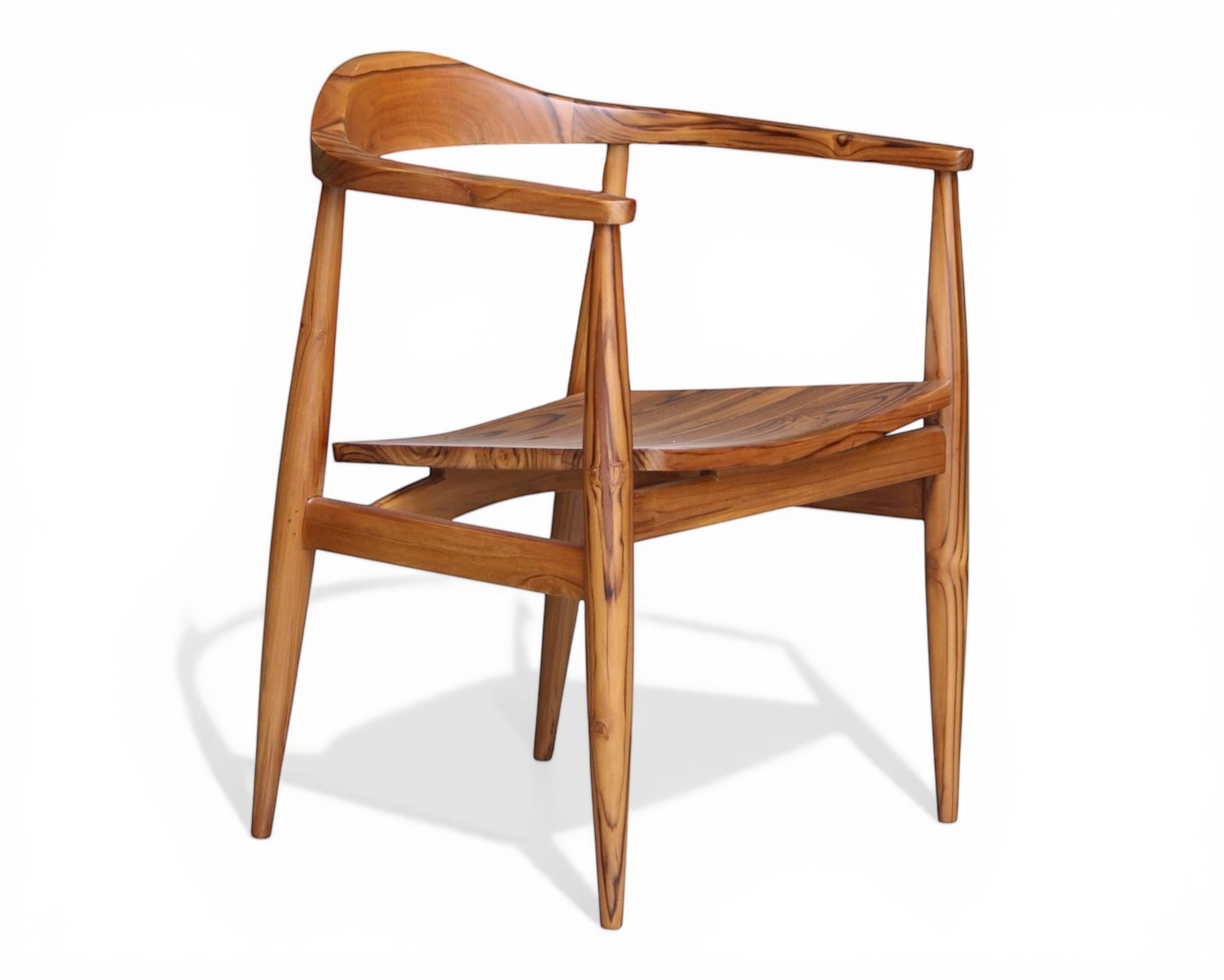 Nakoda Homes solid wood dining chair with curved back and natural wood grain finish.