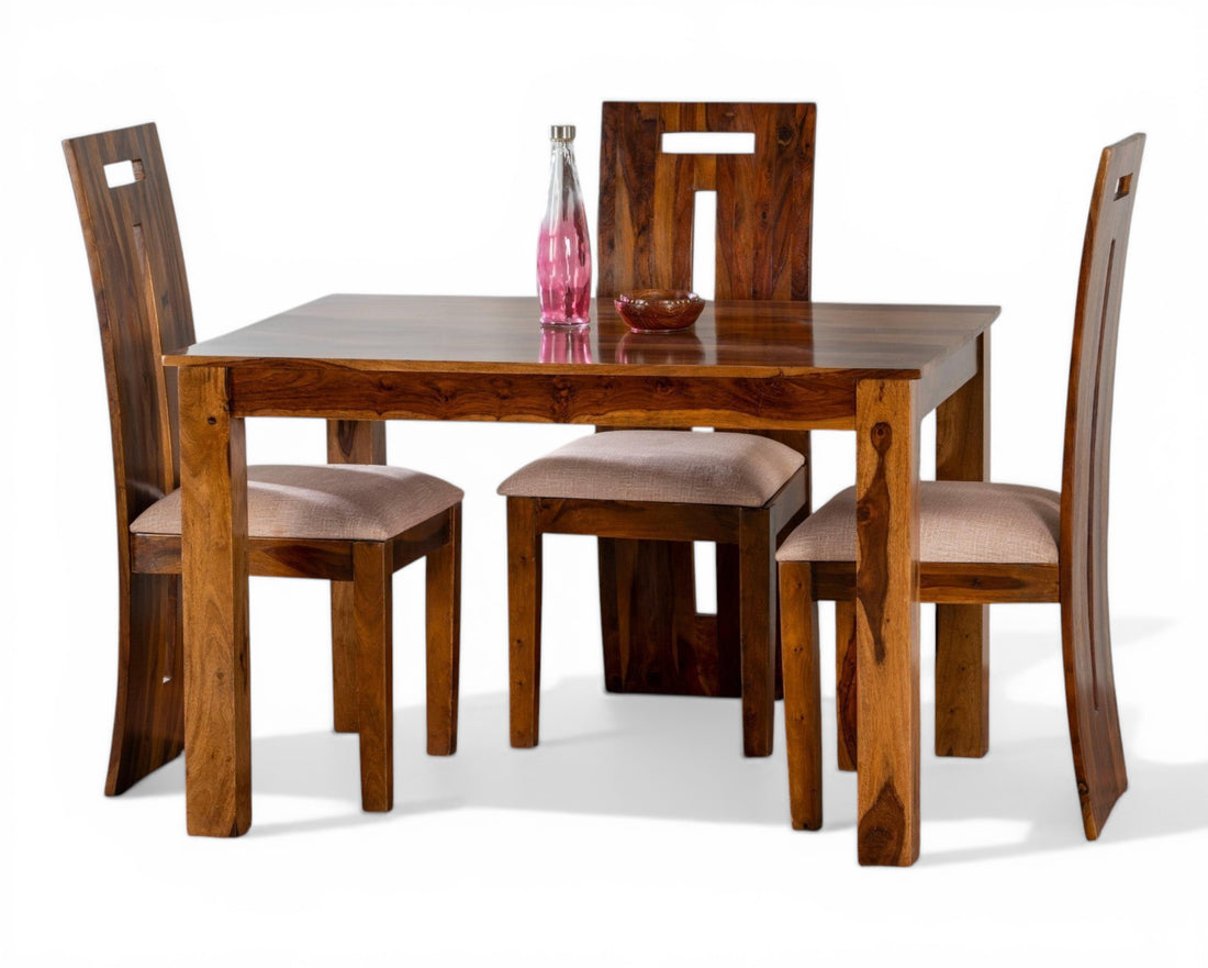 Nakoda Homes solid wood dining set with four chairs featuring upholstered seats and a minimalist design with natural wood grain.