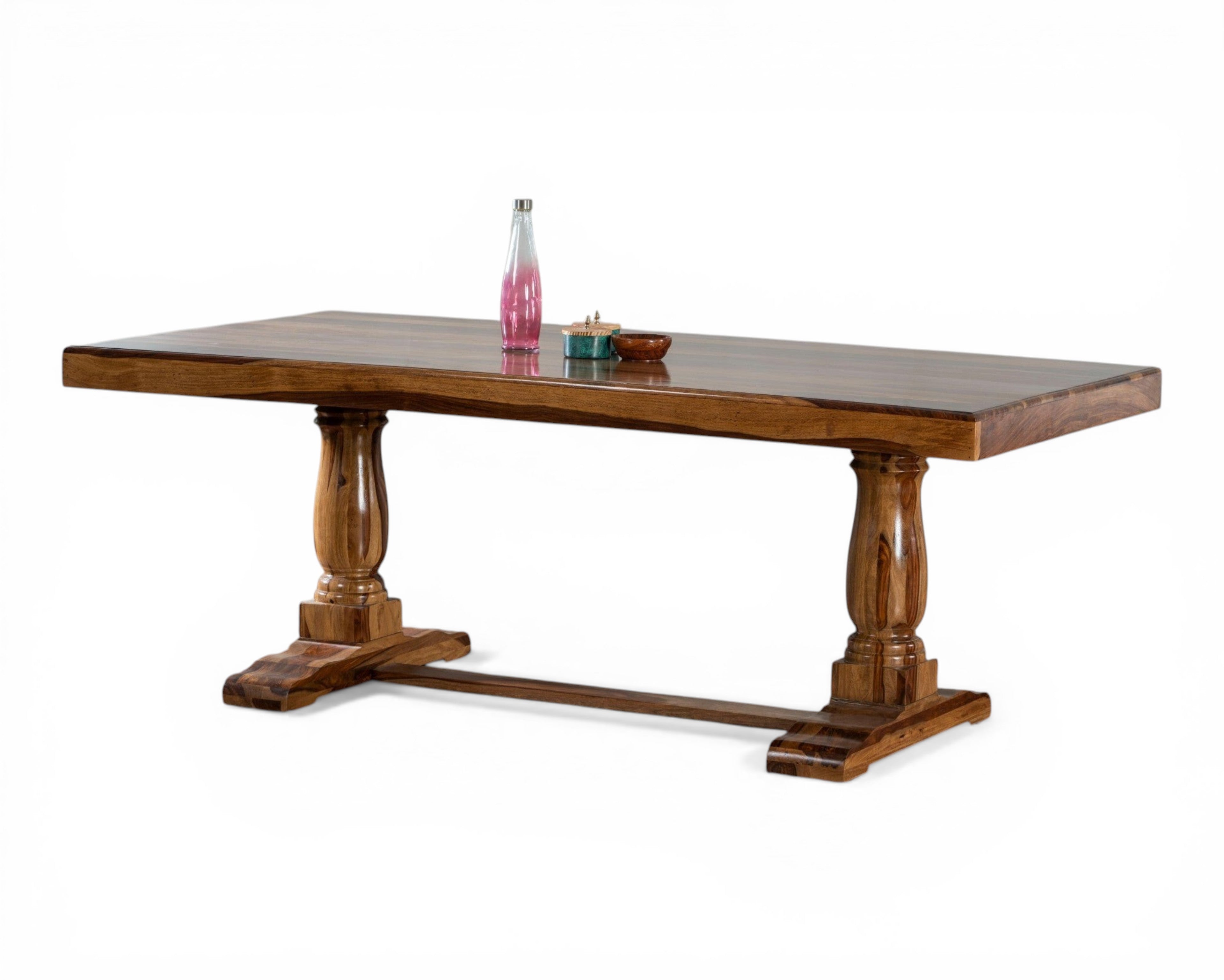 Nakoda Homes solid wood dining table with pedestal legs and matching benches. Warm-toned wood, rustic design.