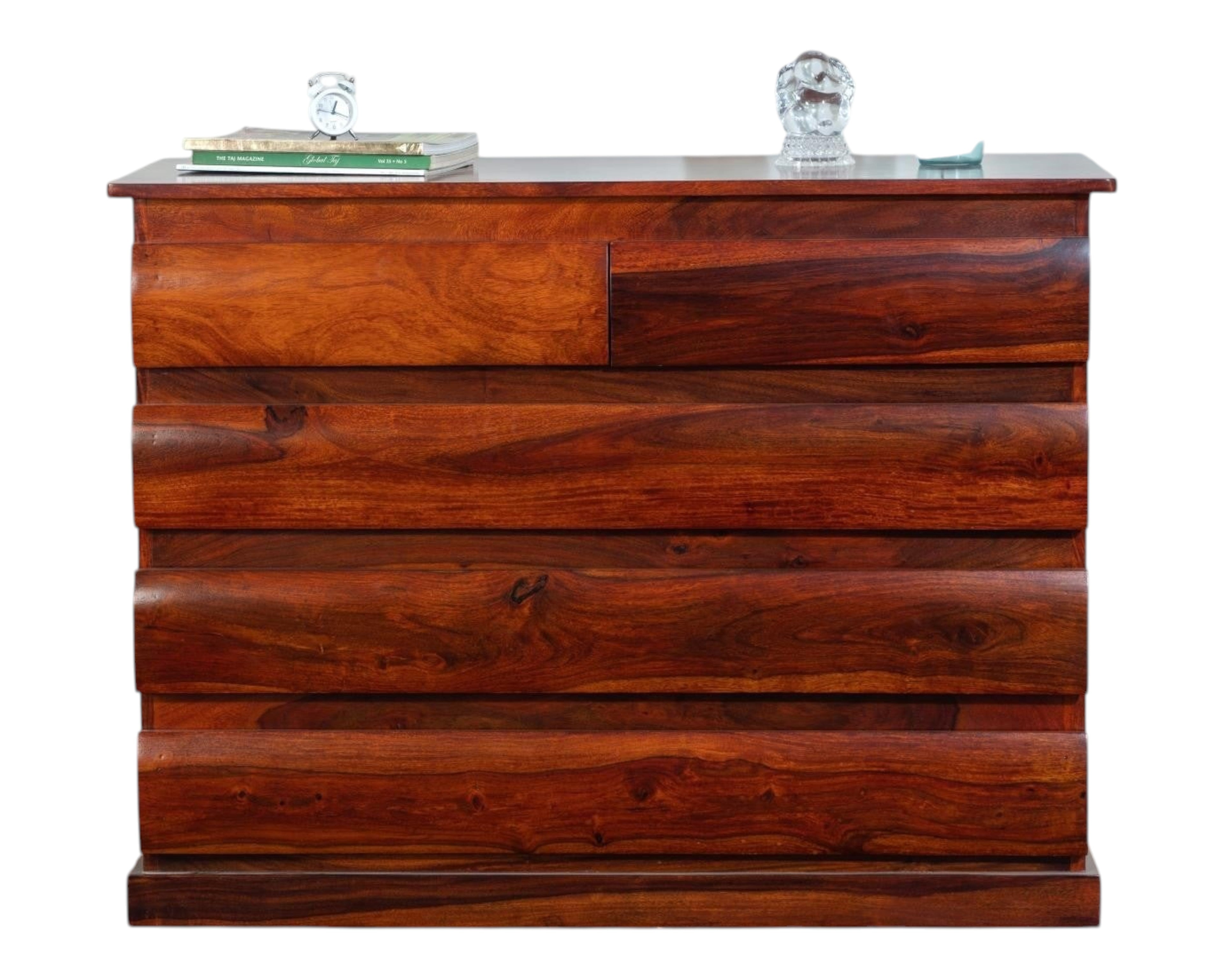 Nakoda Homes solid wood dresser with five drawers featuring curved fronts and natural wood grain. Warm brown finish.