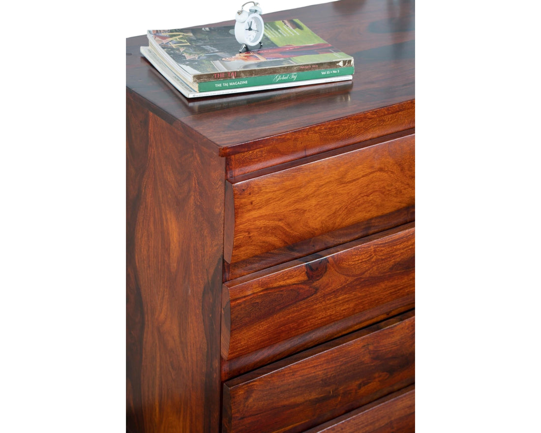 Nakoda Homes solid wood dresser with five drawers featuring subtly curved fronts and natural wood grain.