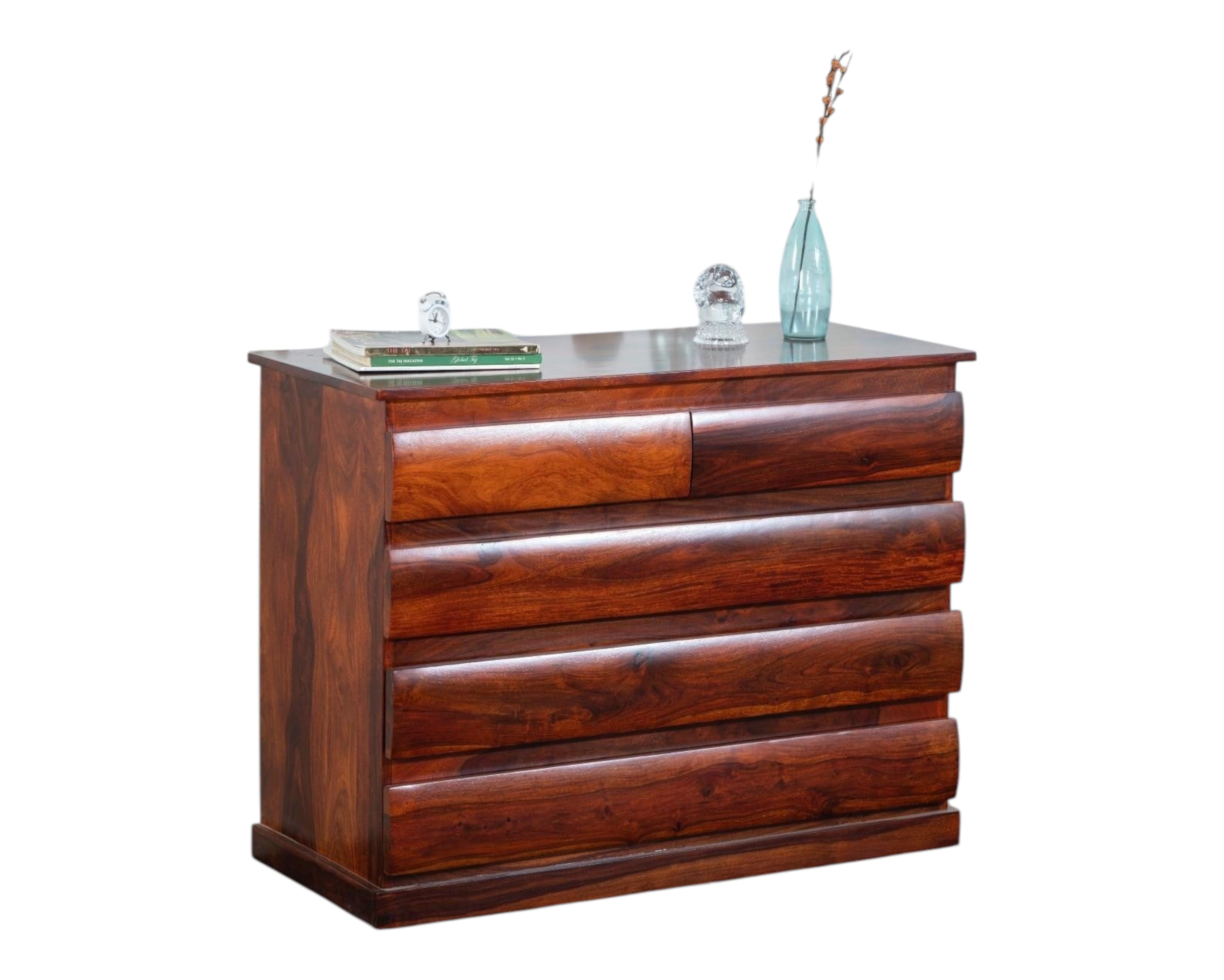 Nakoda Homes solid wood dresser with five drawers featuring curved fronts and natural wood grain. Warm brown finish.