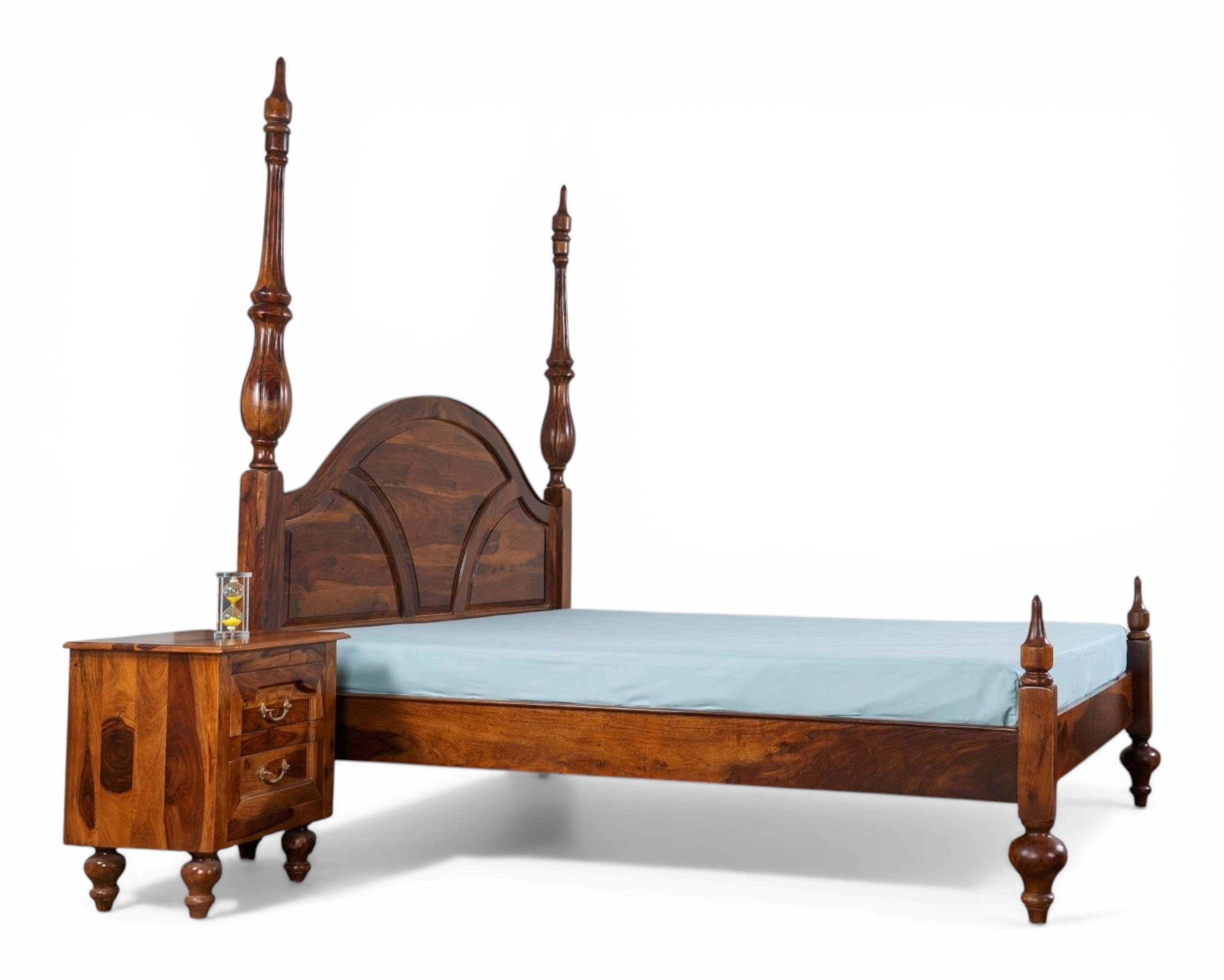 Nakoda Homes solid wood four poster canopy bed with arched headboard and turned posts. Warm wood tone.