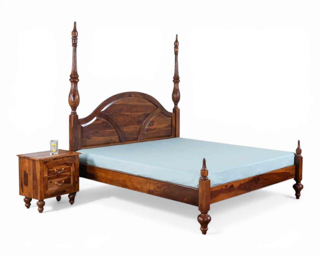 Nakoda Homes solid wood four poster canopy bed with arched headboard and intricate detailing in warm wood tone.