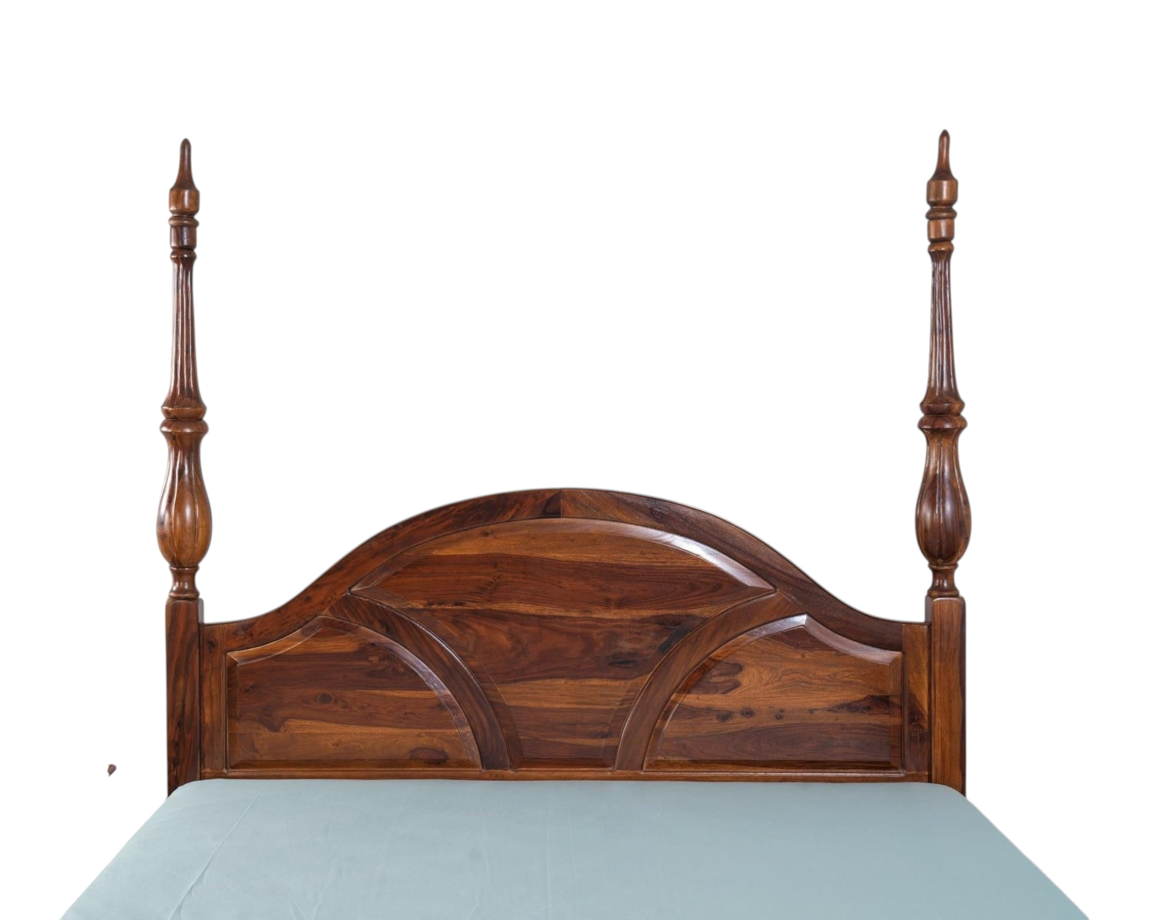 Nakoda Homes solid wood four poster canopy bed with arched headboard and intricate detailing. Warm wood tone.