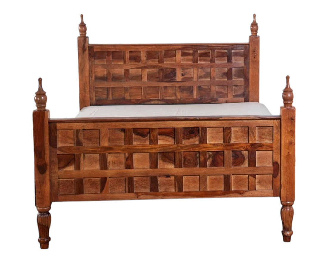 Nakoda Homes solid wood bed frame with lattice headboard, turned posts, and finials. Warm wood tone.