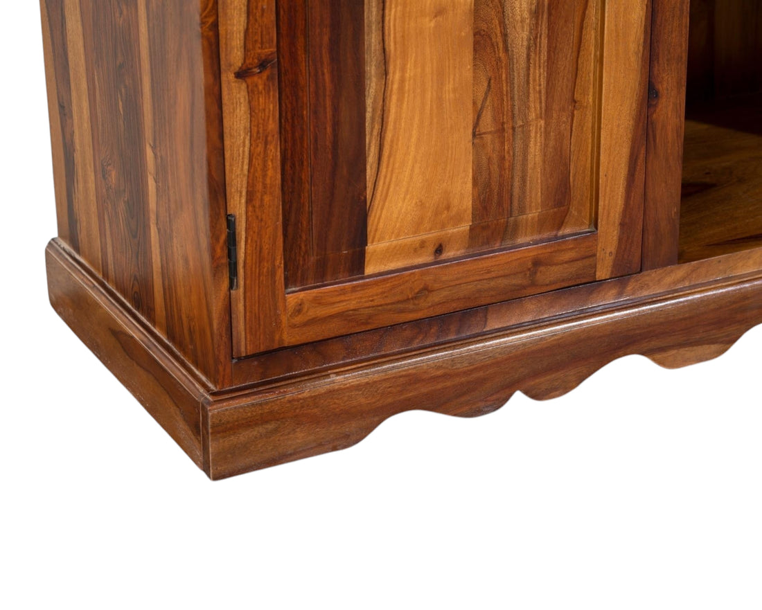 Nakoda Homes solid Sheesham wood media console with cabinet storage and scalloped base.