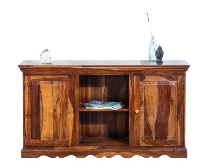 Nakoda Homes solid Sheesham wood media console with two cabinets and open shelf, featuring natural grain patterns and scalloped base.