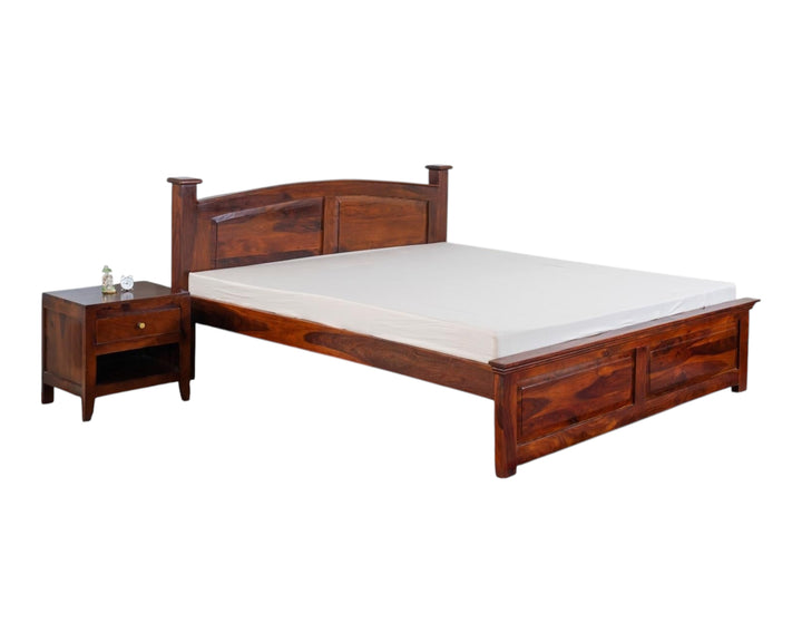 Nakoda Homes solid wood platform bed frame in warm brown with curved headboard and sturdy posts. Elegant design.