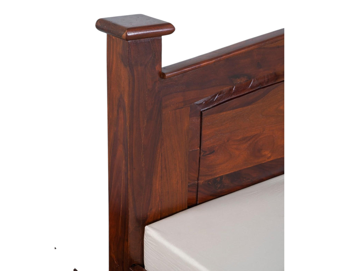 Nakoda Homes solid wood platform bed frame in warm brown with carved headboard detail and sturdy posts.