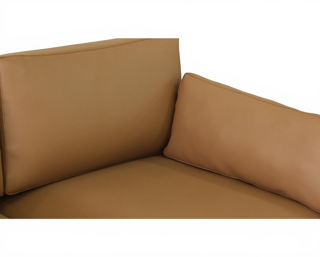 Nakoda Homes modern tan upholstered three-seater sofa with plush cushions and clean lines.