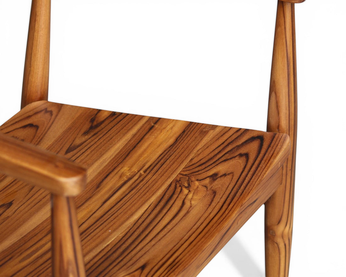 Nakoda Homes solid teak wood dining chair with natural grain and smooth finish. Timeless design for dining room.
