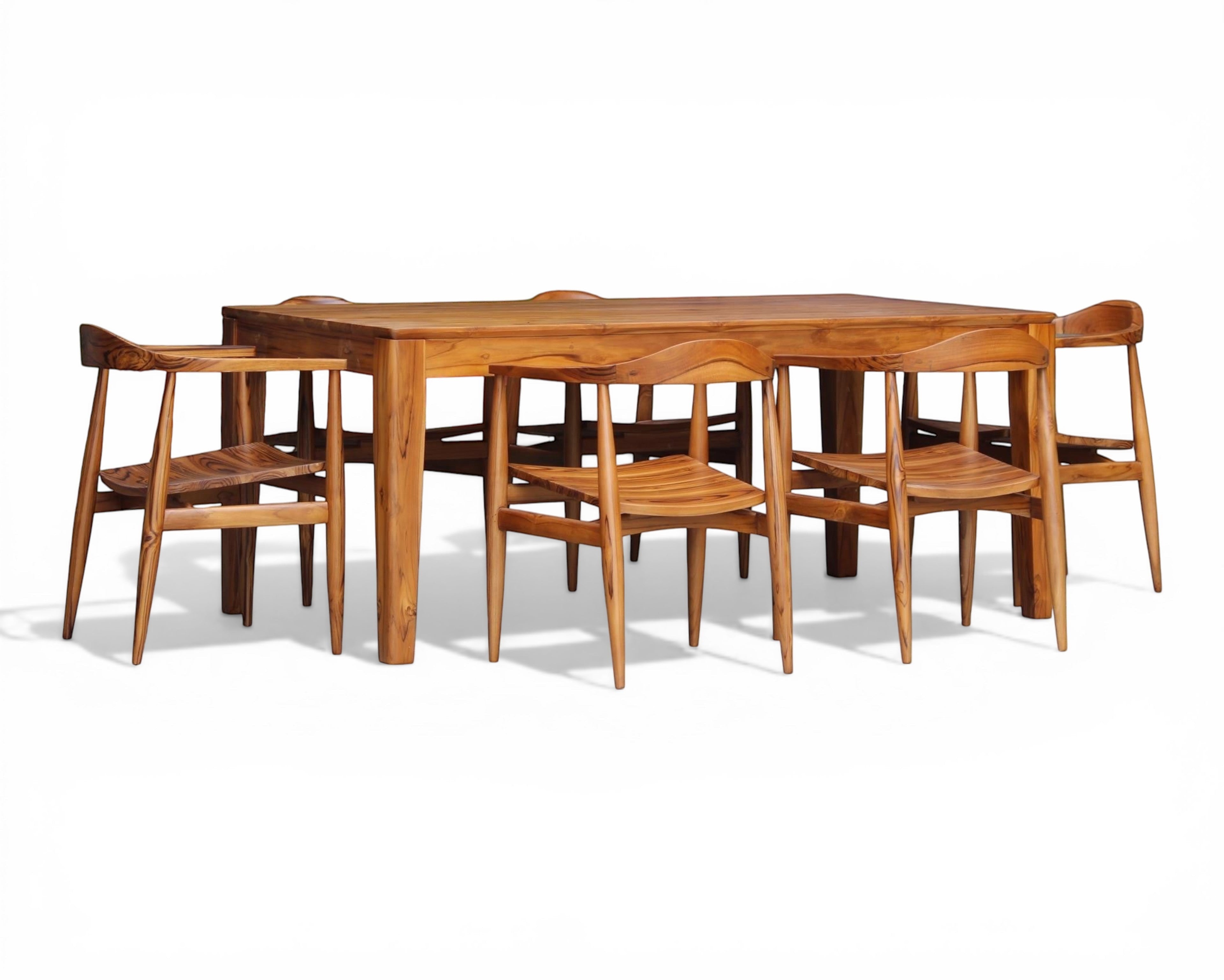Nakoda Homes solid wood teak dining set with six chairs, featuring a smooth warm finish and natural grain. Perfect for dining rooms.
