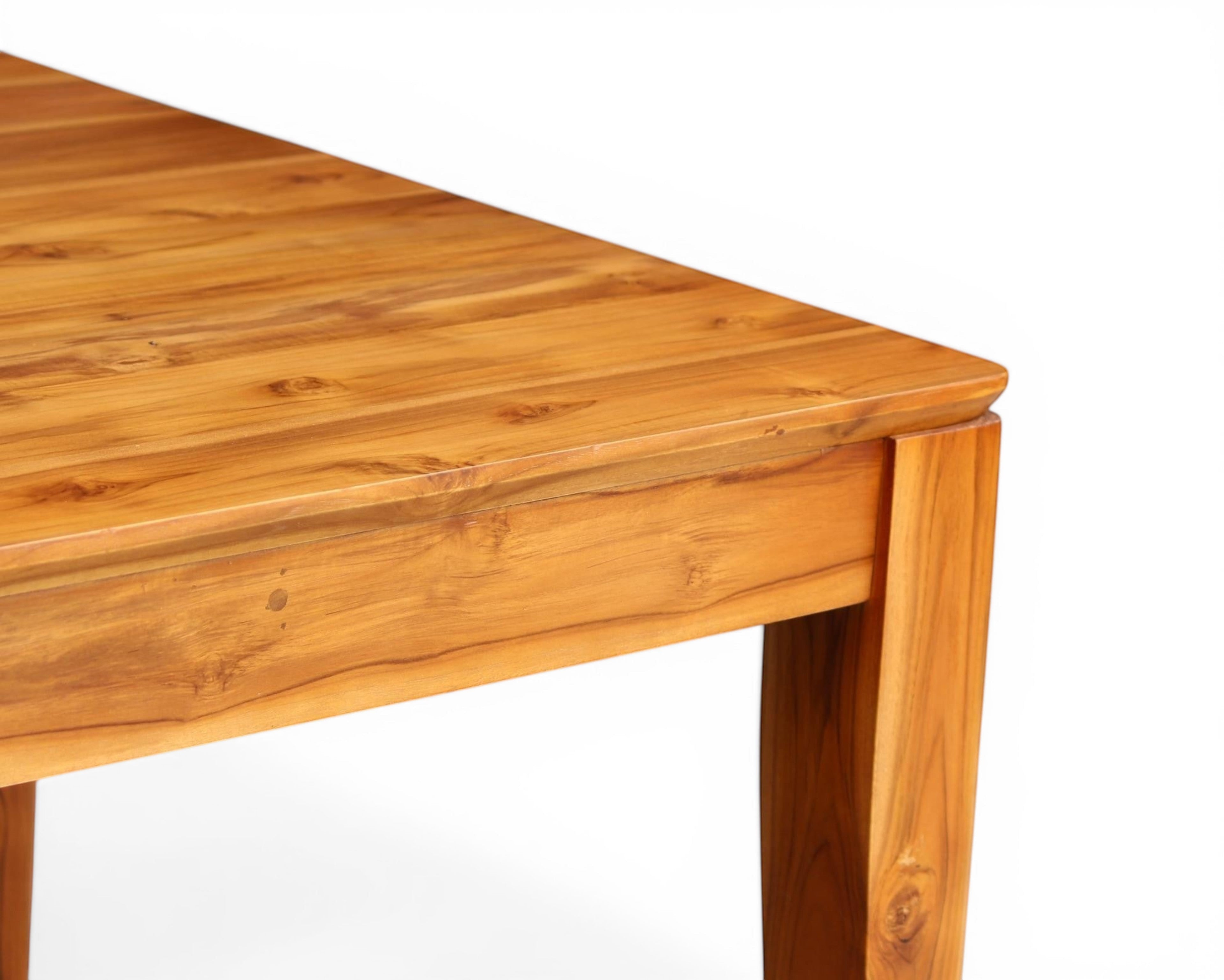 Nakoda Homes solid teak wood dining table with natural grain finish, part of a six-chair set.