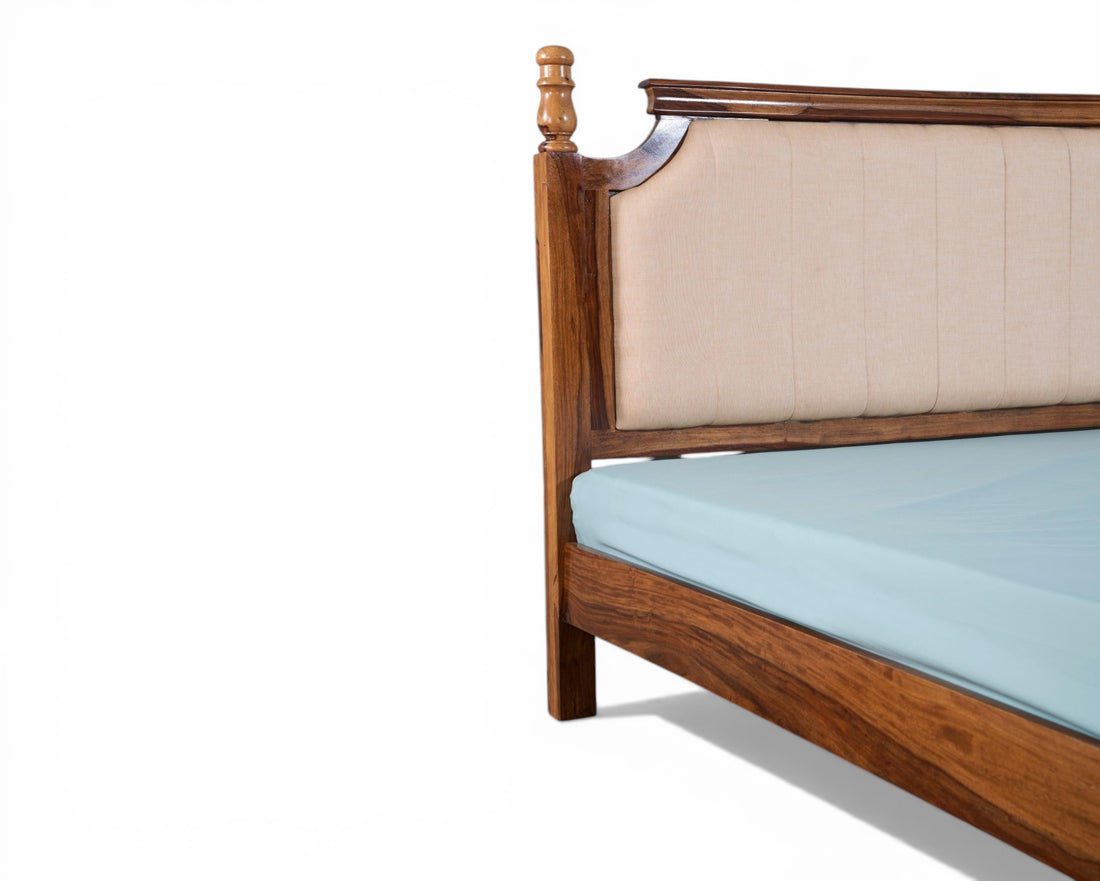 Nakoda Homes classic wooden bed frame with beige upholstered headboard and decorative wood accents.