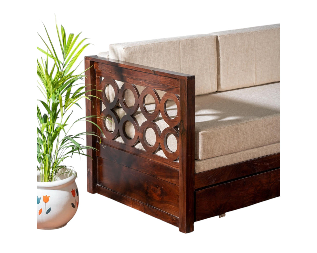 Nakoda Homes dark wood daybed with neutral upholstered seat and circular cut-out armrests.