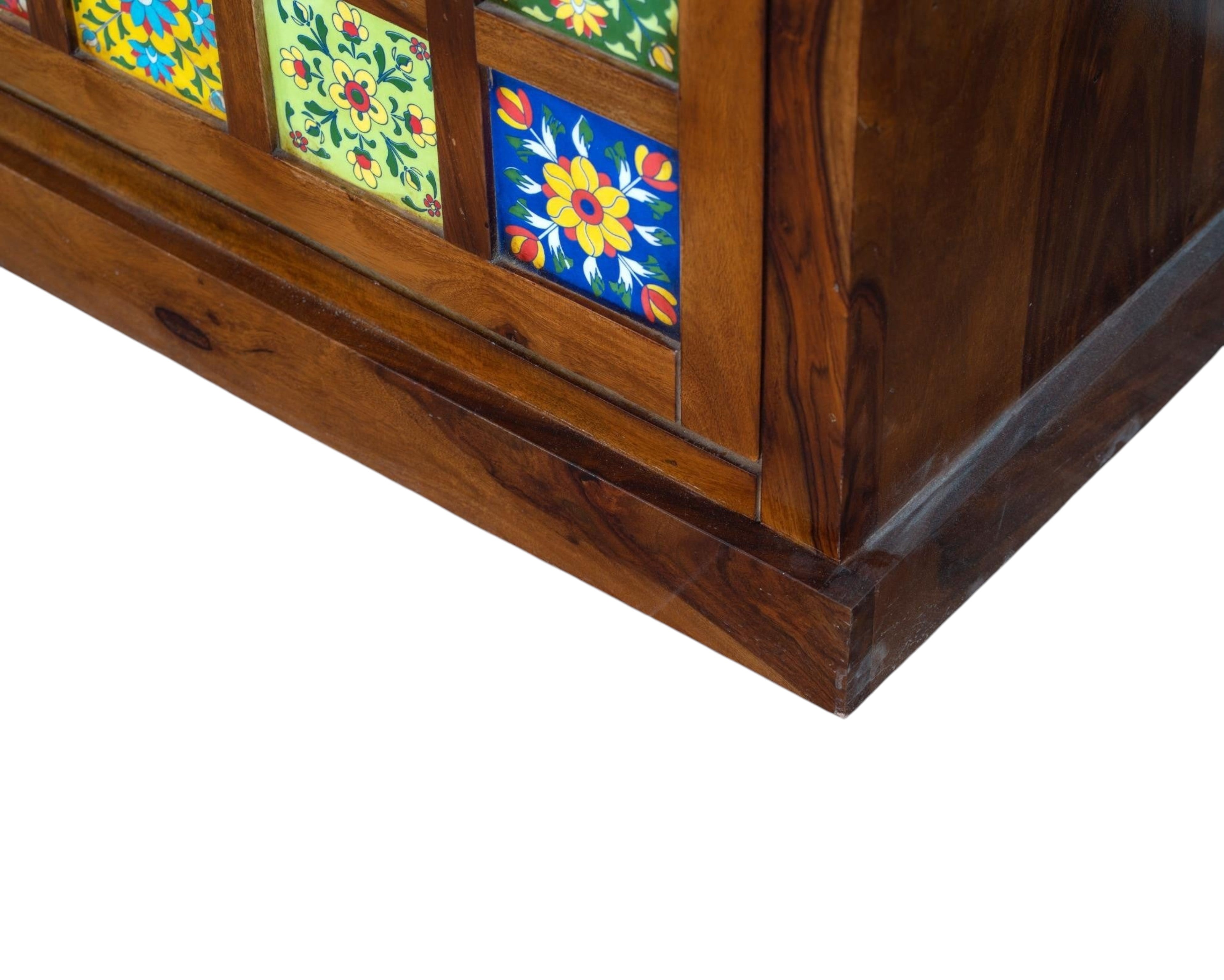 Nakoda Homes wooden shoe cabinet with colorful floral ceramic tiles and upholstered bench seating.