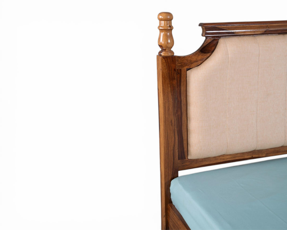 Nakoda Homes classic wooden bed frame with beige upholstered headboard and decorative wood accents.