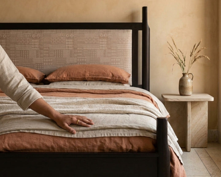 Nakoda Homes modern black metal platform bed frame with beige upholstered headboard featuring geometric pattern. Includes under-bed storage.