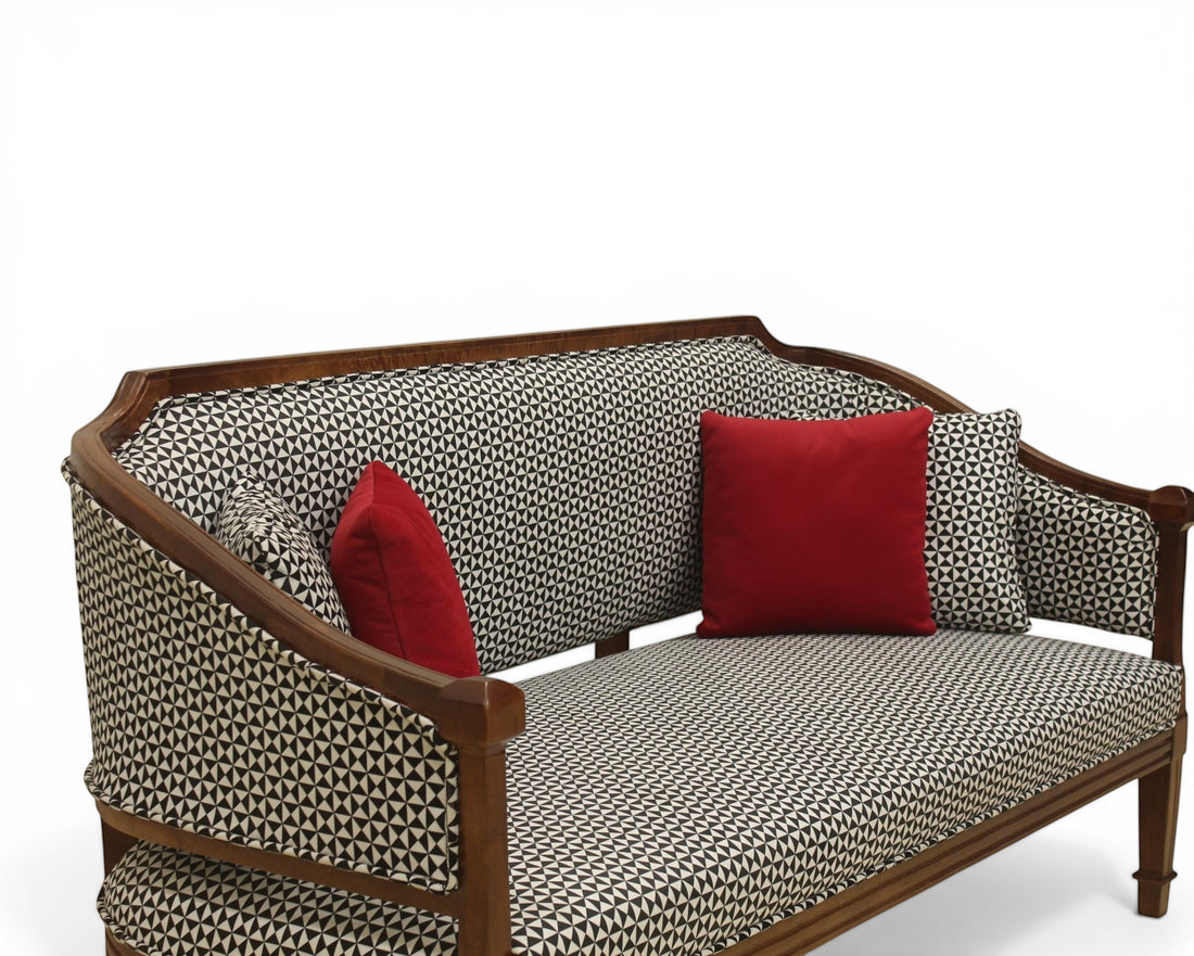 Nakoda Homes classic armchair and sofa set with wooden frame, black and white geometric upholstery, and red accent pillows.
