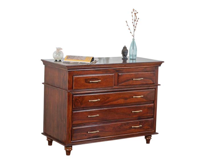 Nakoda Homes classic solid wood chest of drawers in warm brown with brass hardware and turned legs.