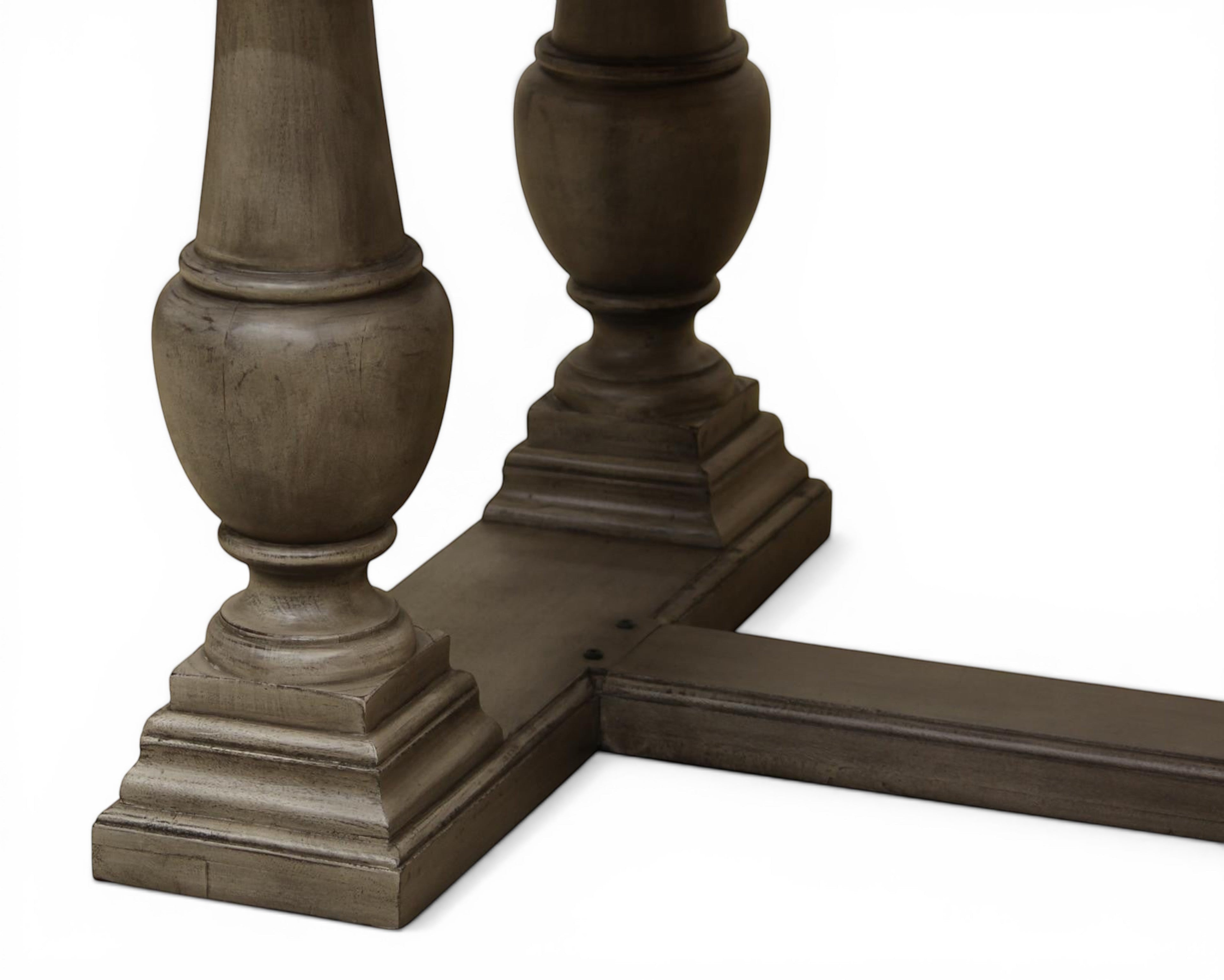Nakoda Homes ornate grey wood pedestal dining table with carved edge and rectangular top. Classic elegance.