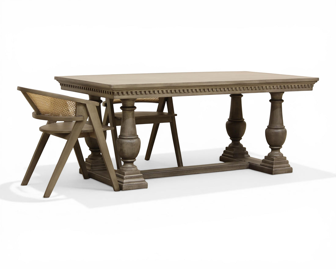 Nakoda Homes ornate grey wood dining table with carved edge and pedestal legs. Rectangular top, classic elegance.
