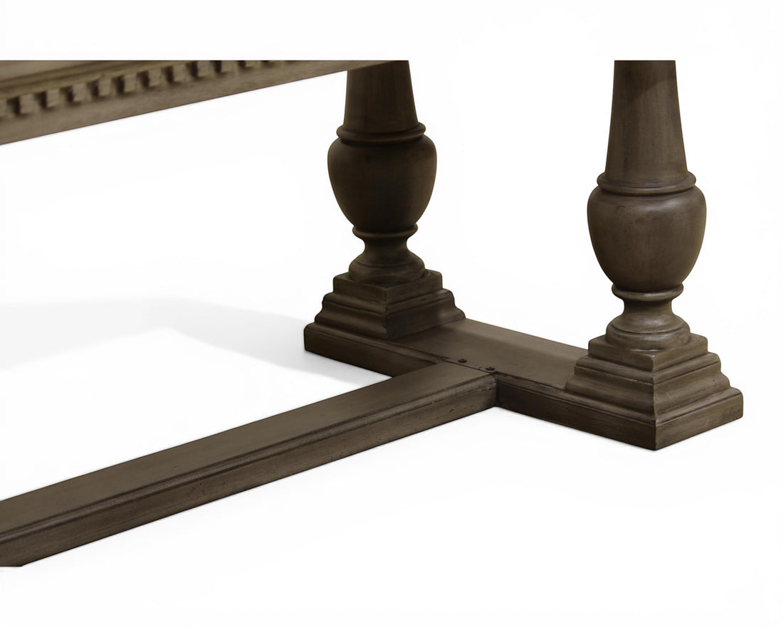 Nakoda Homes ornate grey wood pedestal dining table with carved edge and rectangular top.