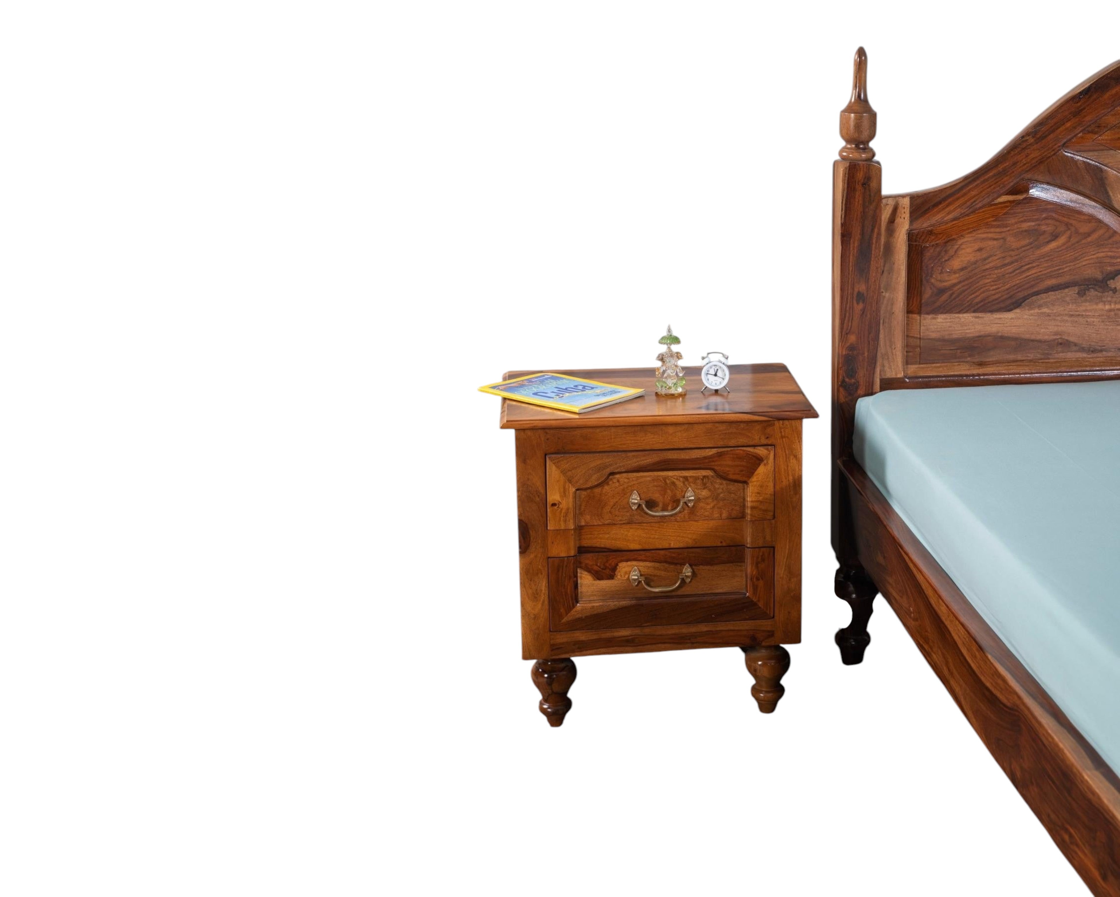 Nakoda Homes Ornate Sheesham wood bed frame with arched headboard, intricate carvings, and turned posts. Warm wood tone.