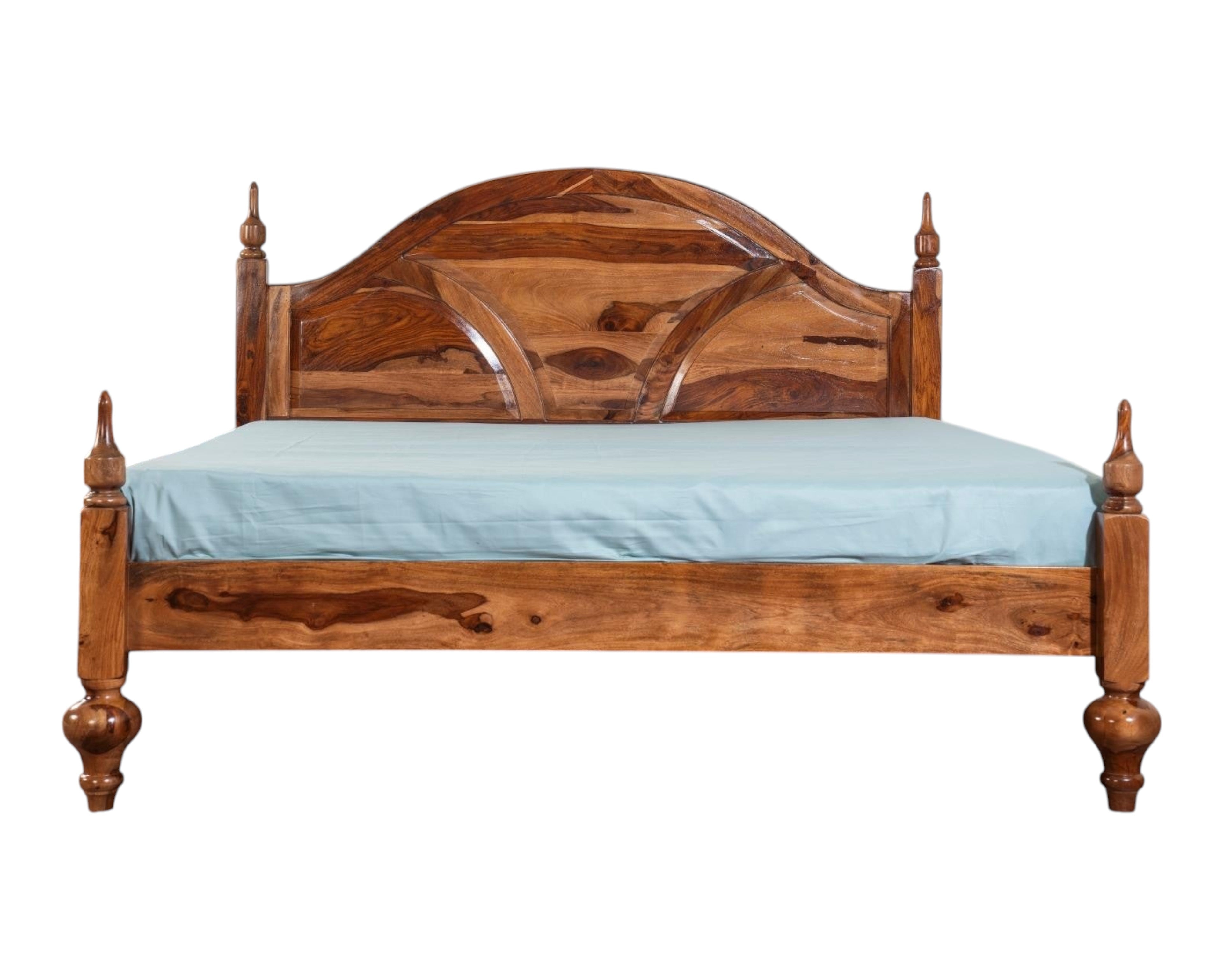 Nakoda Homes Ornate Sheesham wood bed frame with arched headboard, intricate carvings, and turned posts.