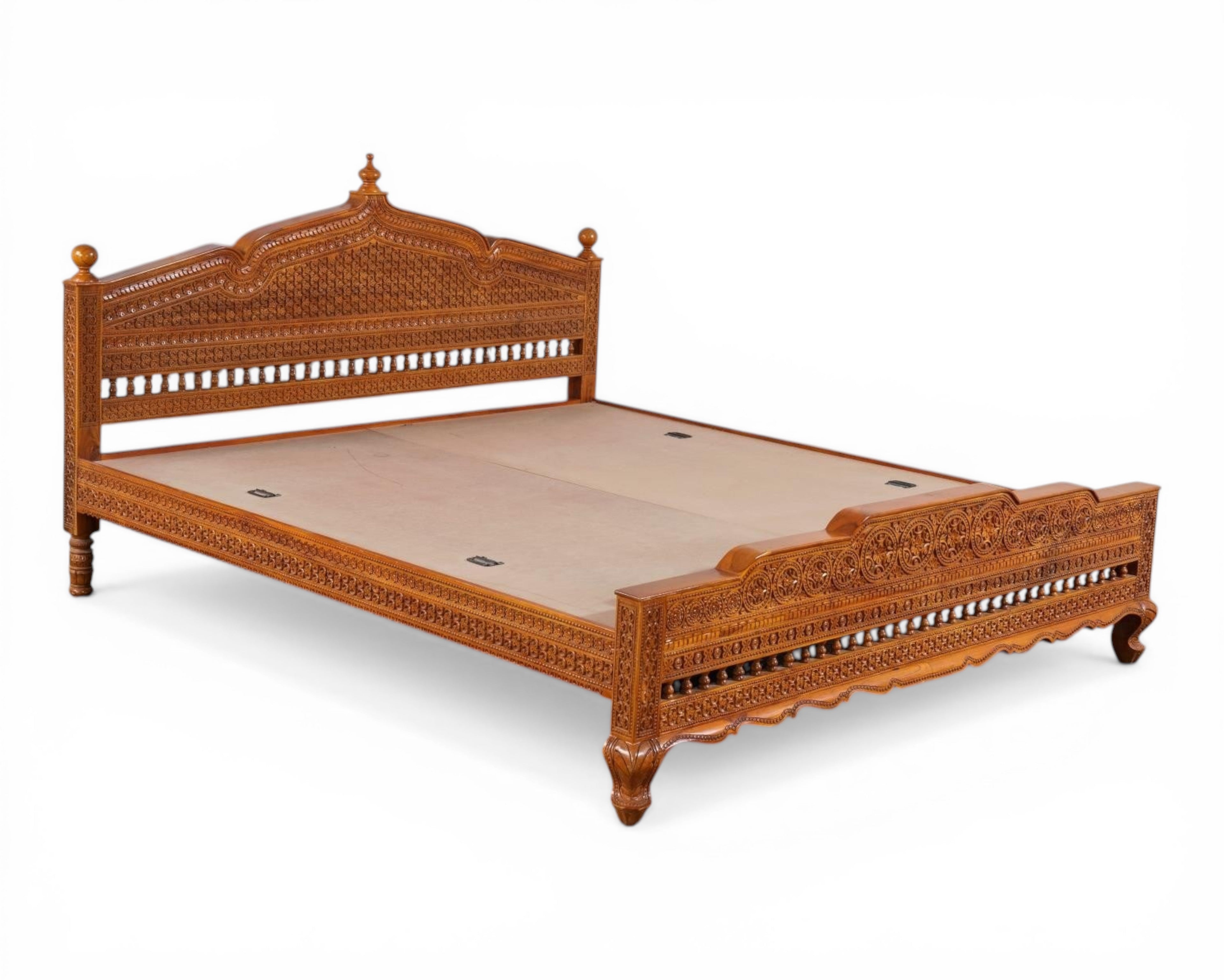Nakoda Homes ornate carved wooden bed frame with intricate details and warm wood finish. Traditional craftsmanship.